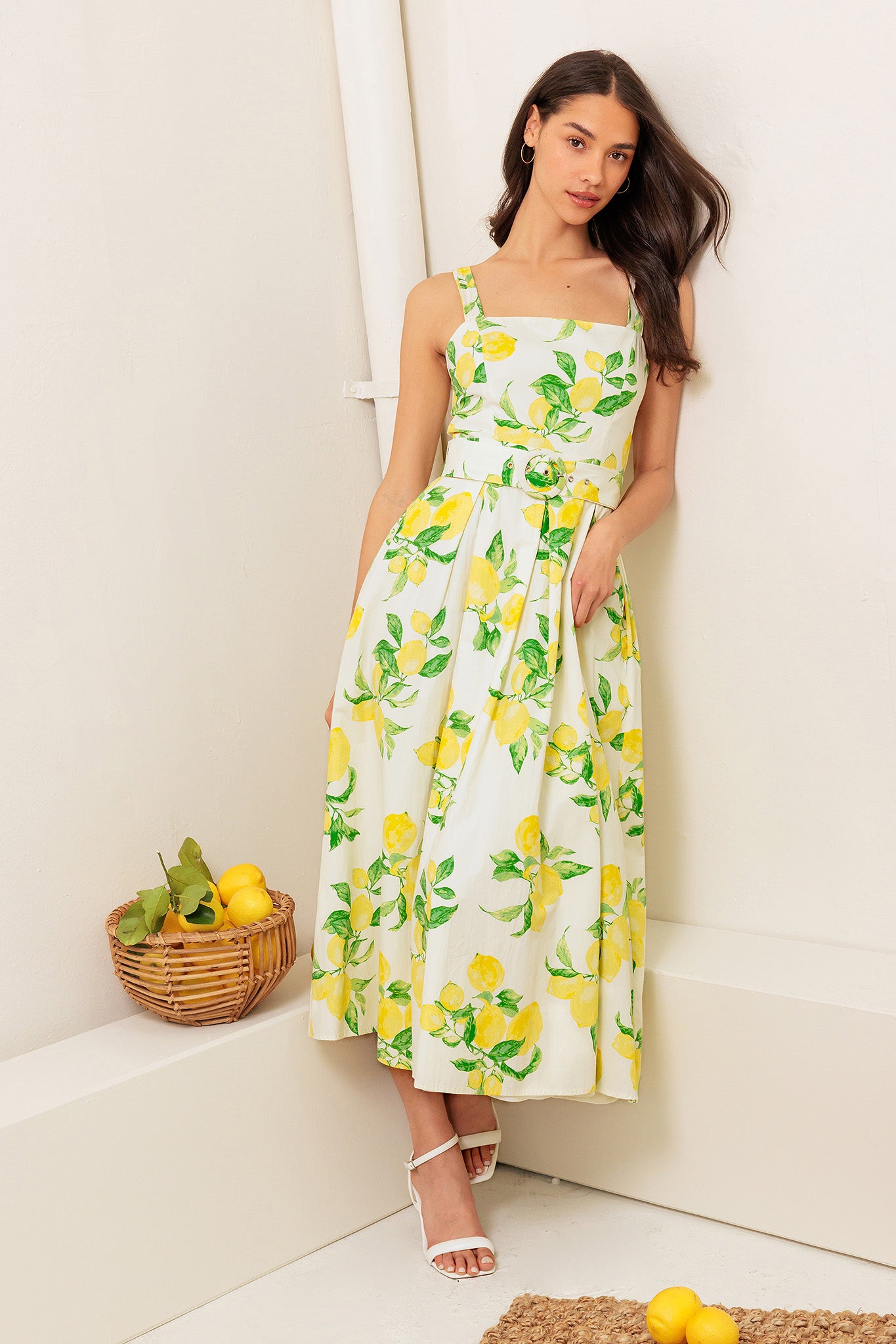 A printed woven midi dress featuring straight neckline, straps, self belt, full skirt and back zipper closure.