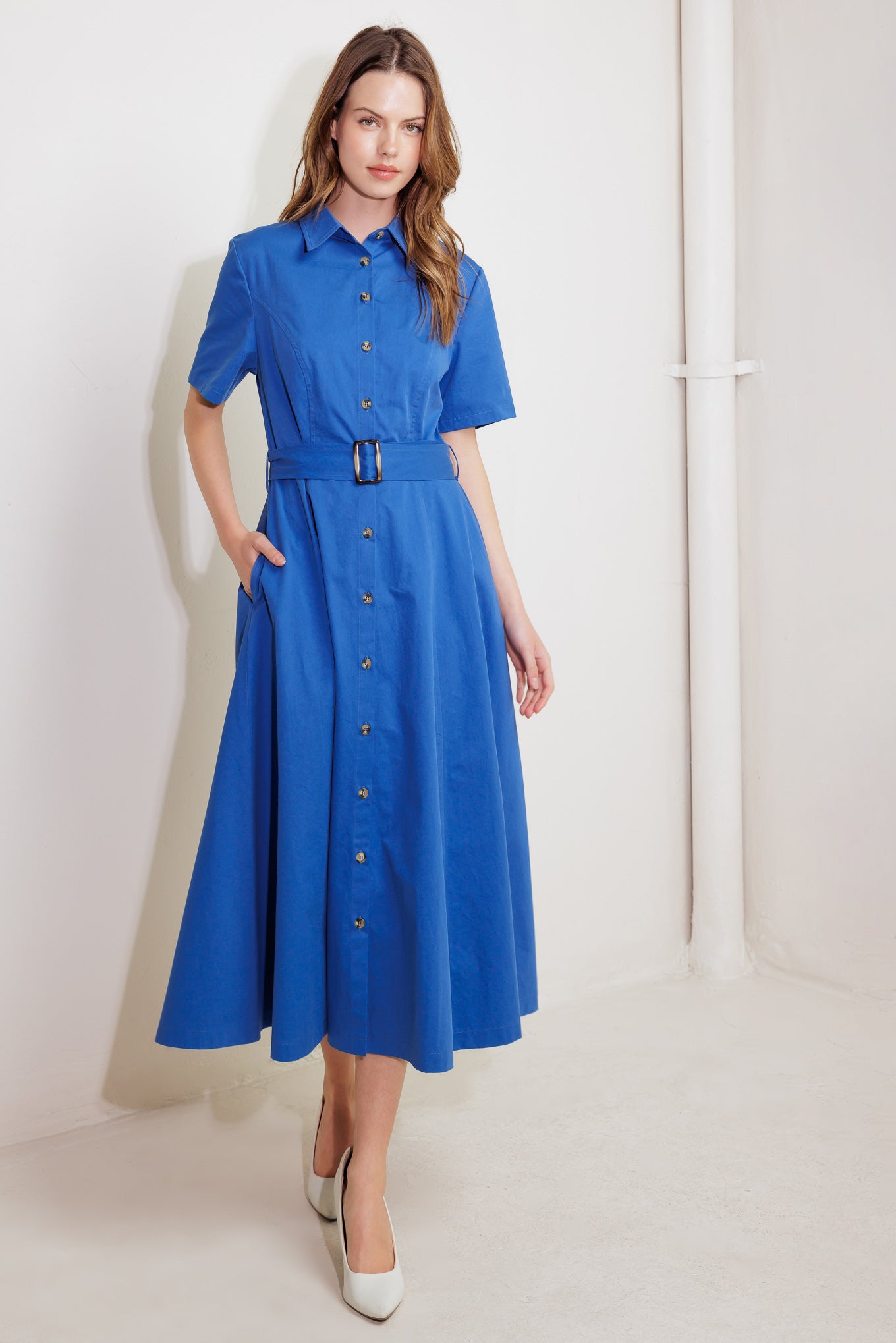 A solid blue woven midi dress featuring shirt collar, button down, short sleeve, side pocket and self belt