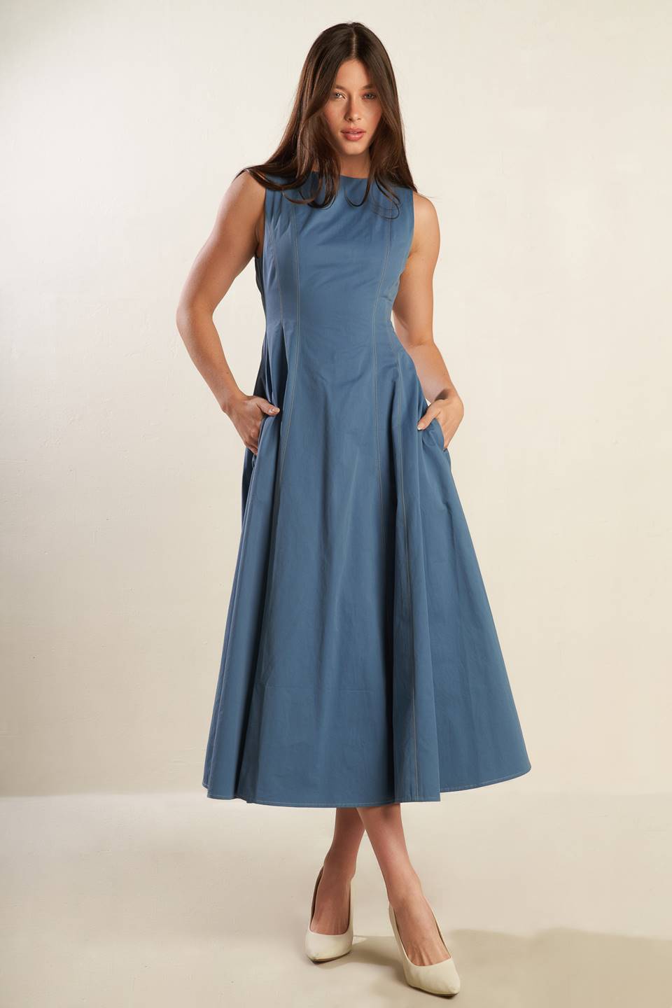 A solid woven midi dress featuring round neckline, sleeveless, full skirt and back zipper closure.