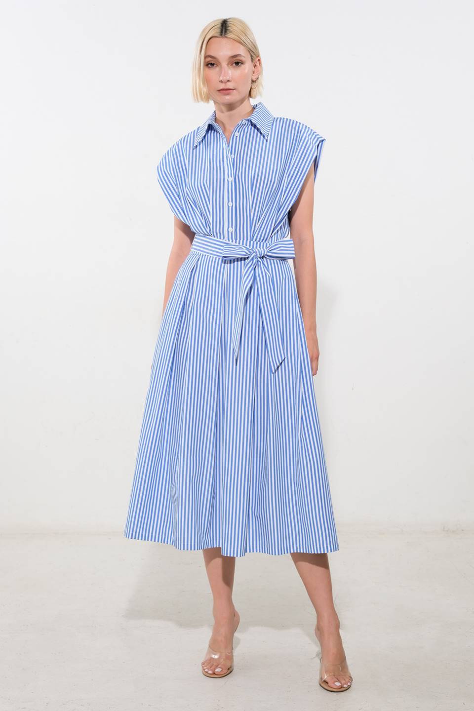 A striped woven midi dress featuring shirt collar, button down, drop shoulder, pleated skirt and self sash tie