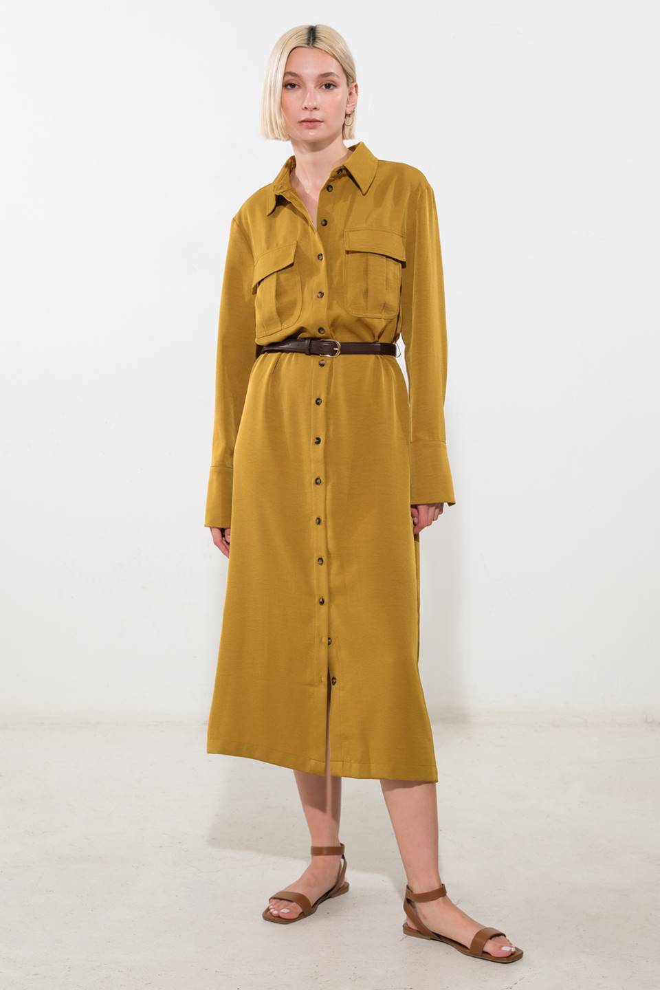 A solid woven midi dress featuring shirt collar, long sleeve, front cargo pockets, button down and belt
Details:
Self : 100% Polyester
Size & Fit
- Model is 5`8" And Wearing Size Small
- Measurements Taken From Size Small
- Approx. Length: 50"