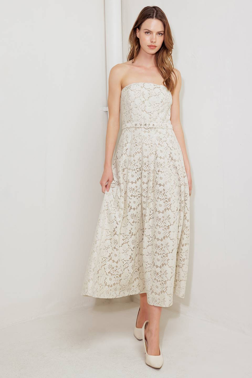 A strapless, woven lace midi dress featuring straight neckline, self belt, full skirt and back zipper closure