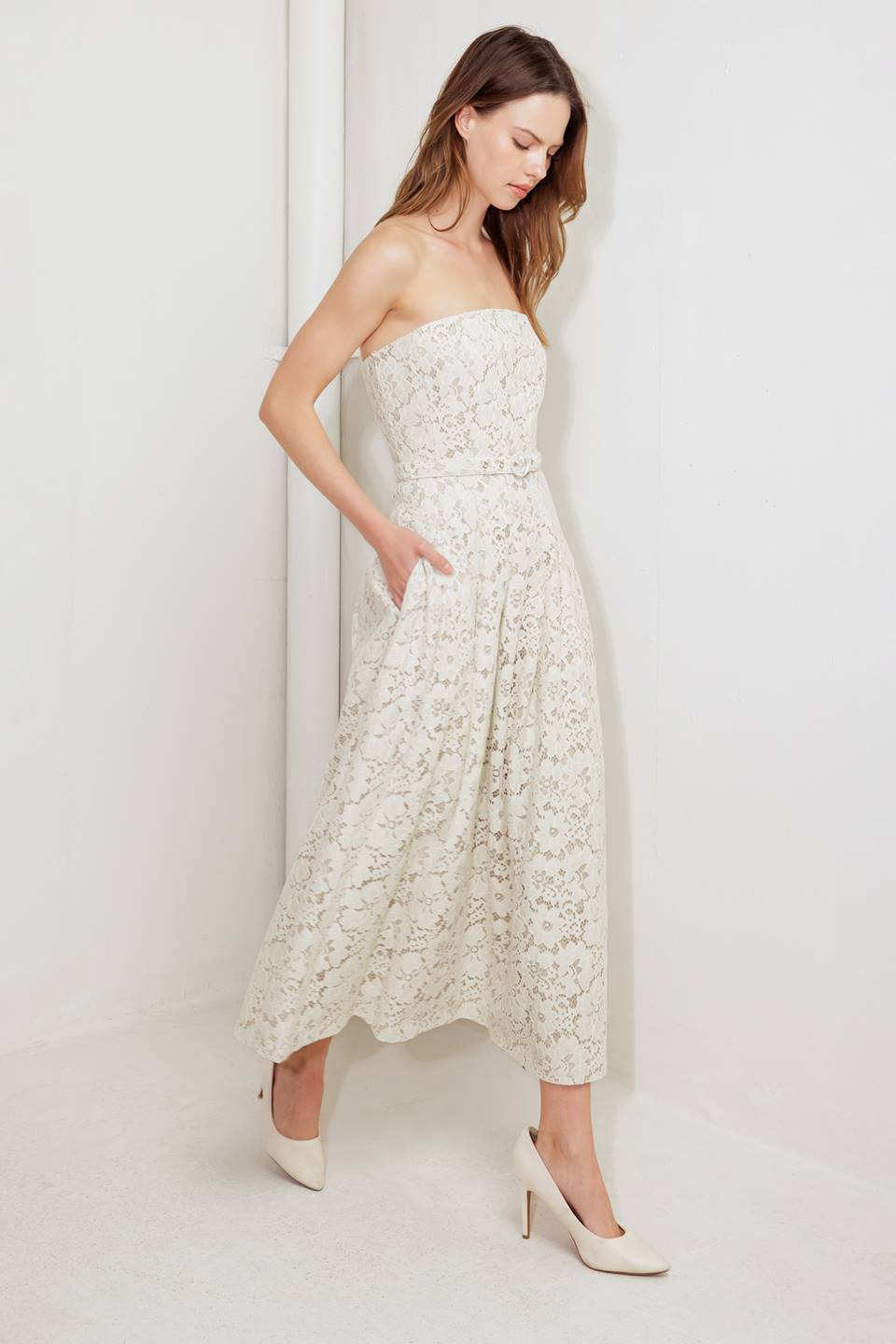 A strapless, woven lace midi dress featuring straight neckline, self belt, full skirt and back zipper closure