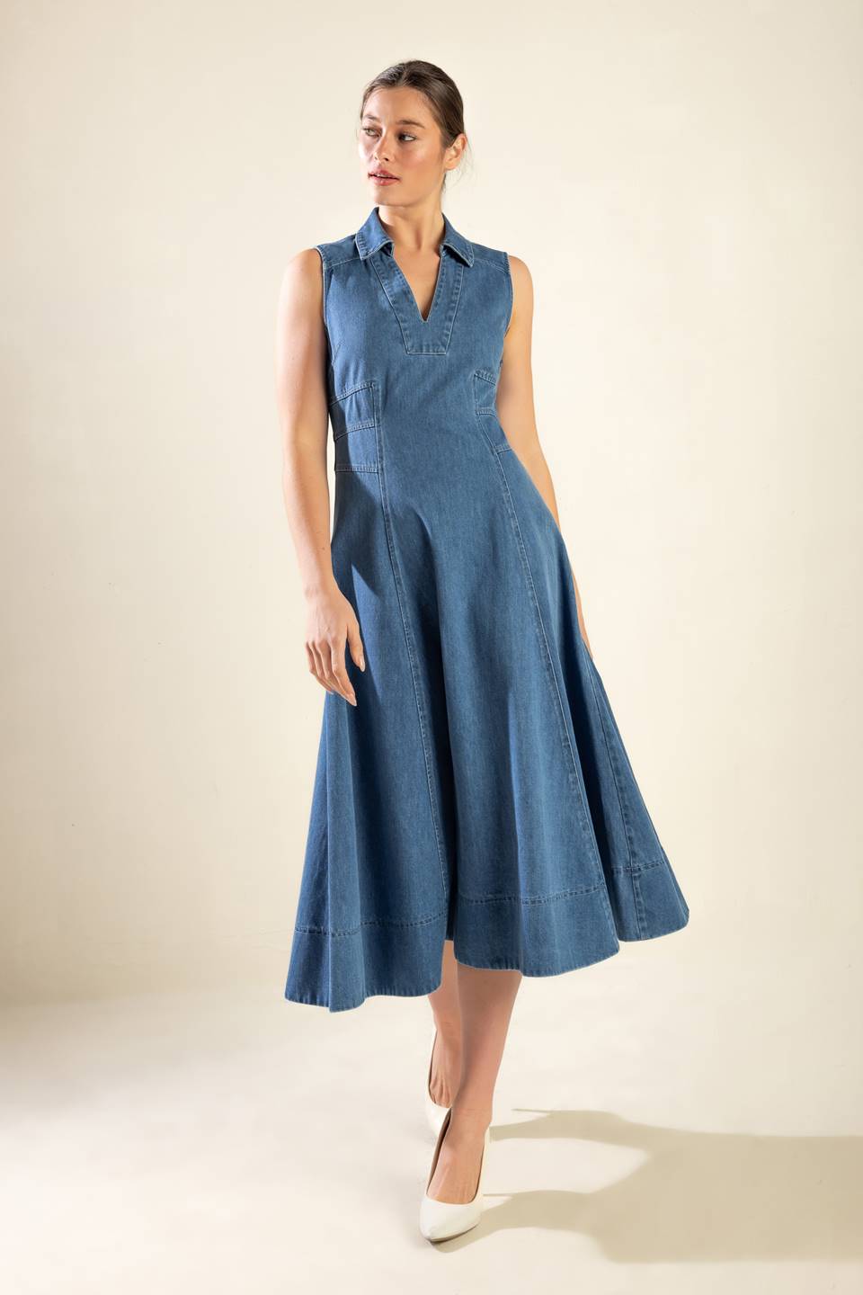 A washed denim midi dress featuring collar, V neckline, sleeveless, A line full skirt and side zipper closure