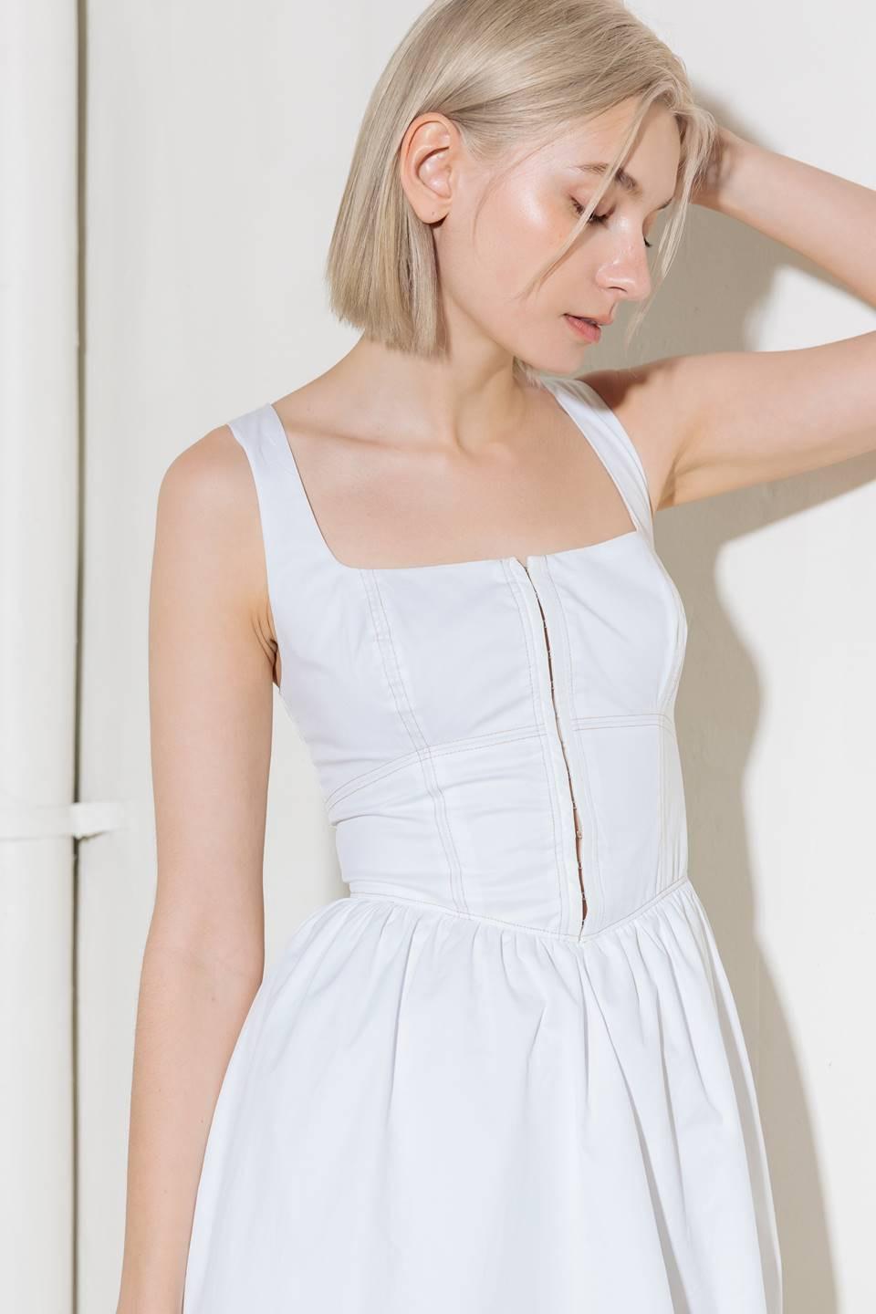 A solid woven midi dress featuring square neckline, sleeveless, front hook and eye closure, full skirt and back zipper closure.