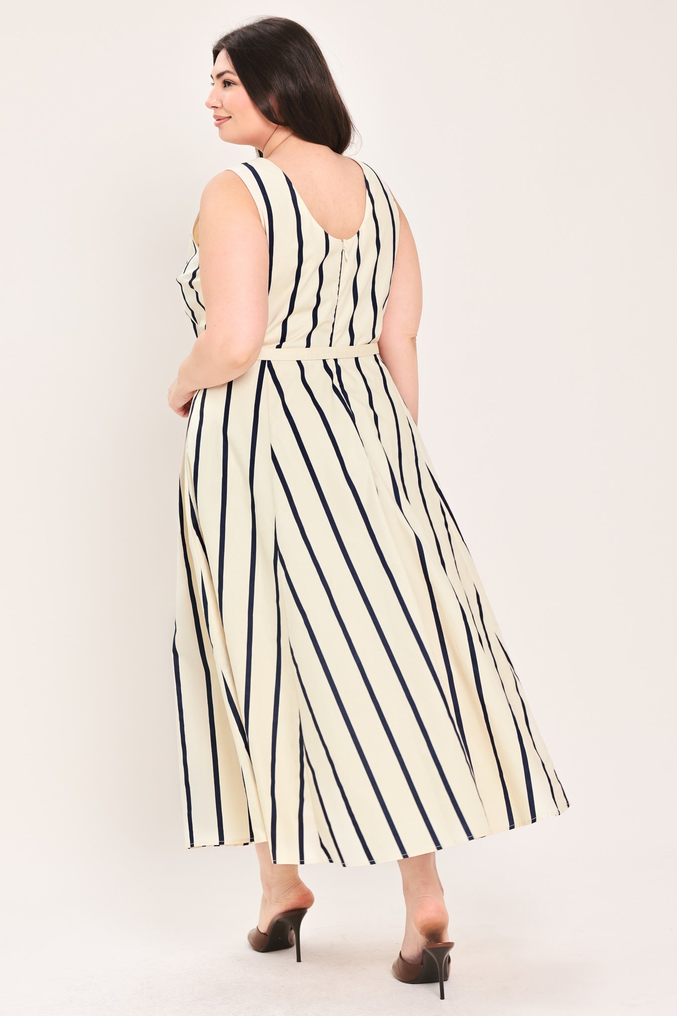Woman wearing a navy and white striped midi dress featuring wide neckline, sleeveless, self belt, full skirt, low back with zipper closure | FREEMARKET