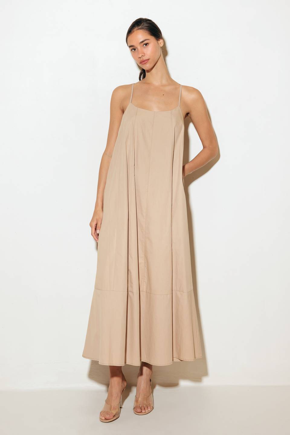 Crafted with a solid woven texture and a stylish taupe hue, this midi tent dress offers a versatile addition to your wardrobe. Featuring a convenient back strap closure, it's a functional and chic option for any occasion.