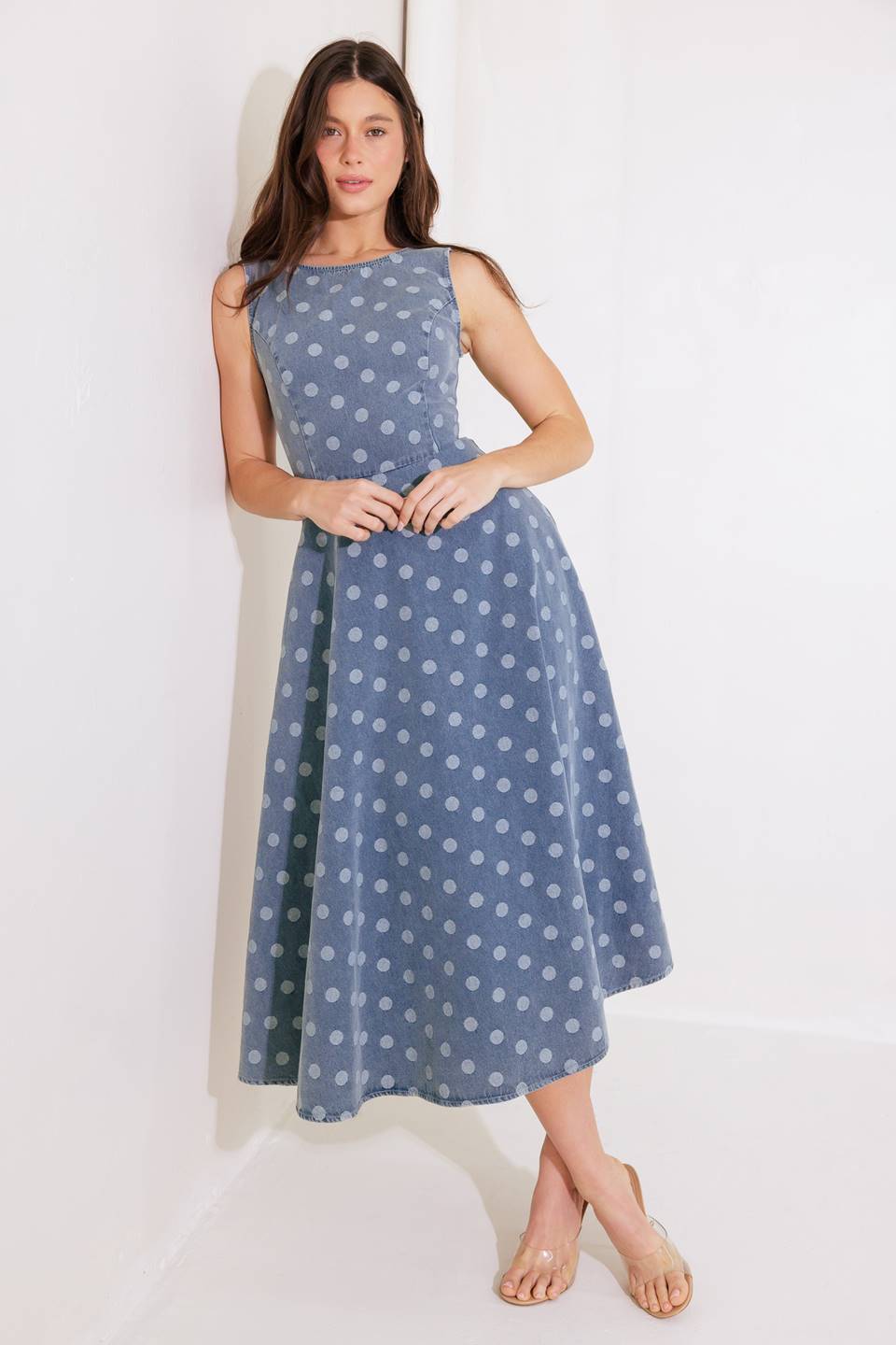 A printed denim midi dress featuring round neckline, sleeveless, circle skirt, low back with zipper closure