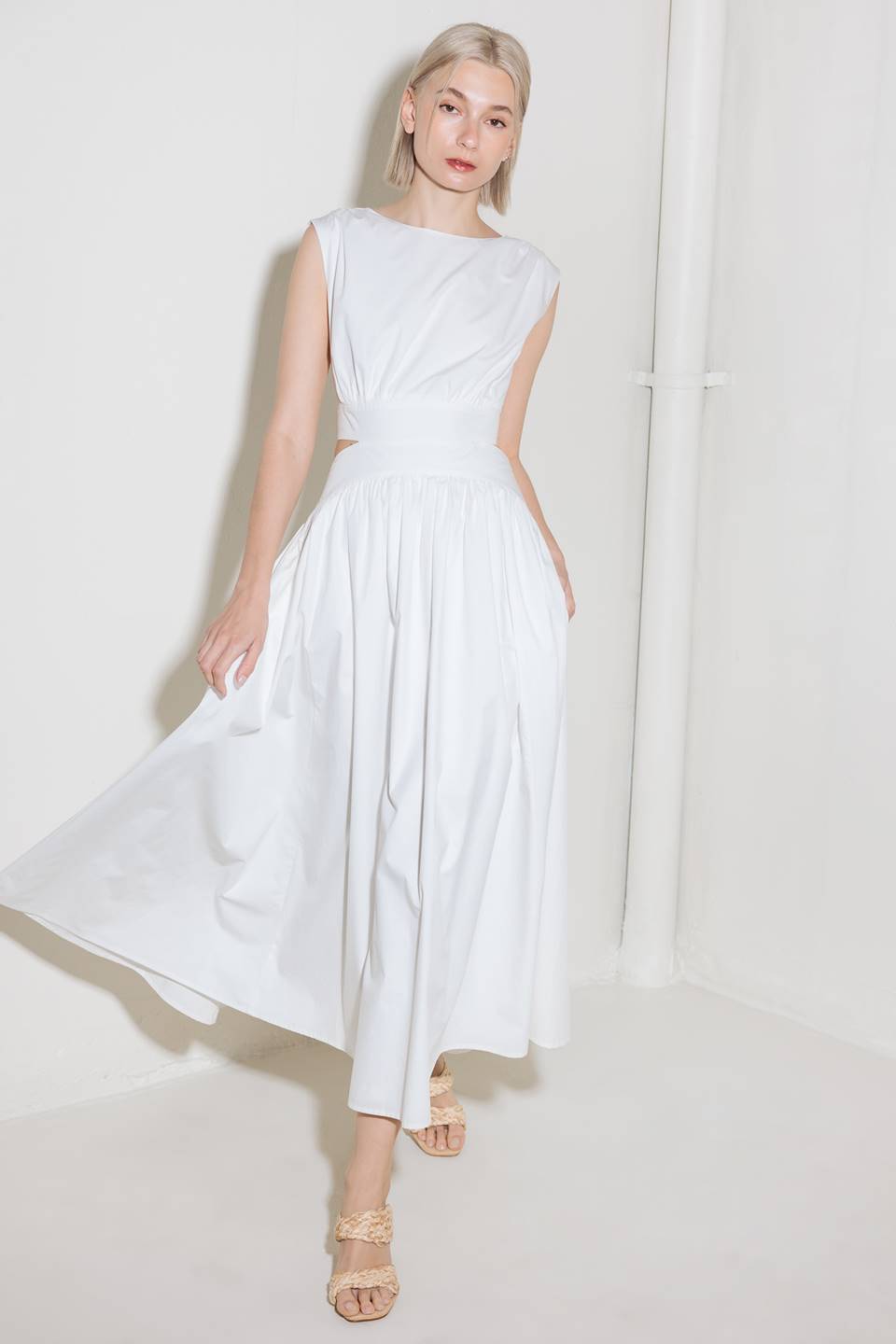 A solid woven midi dress featuring round neckline, sleeveless, side/back cut out, full skirt, side pocket and back zipper closure.