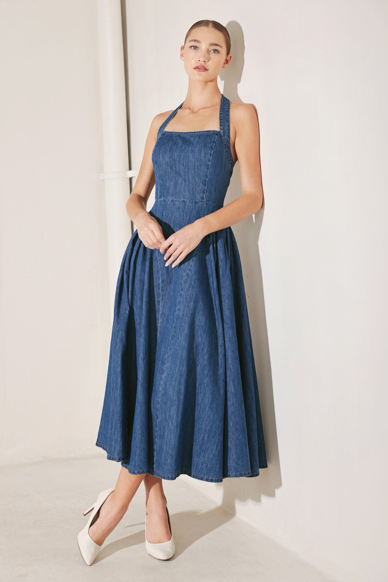 A washed denim midi dress featuring halter neckline, side shirred full skirt, bare back and zipper closure
Details:
Self : 85% Cotton 15% Polyester
Size & Fit
- Model is 5`8" And Wearing Size Small
- Measurements Taken From Size Small
- Approx. Length: 55"