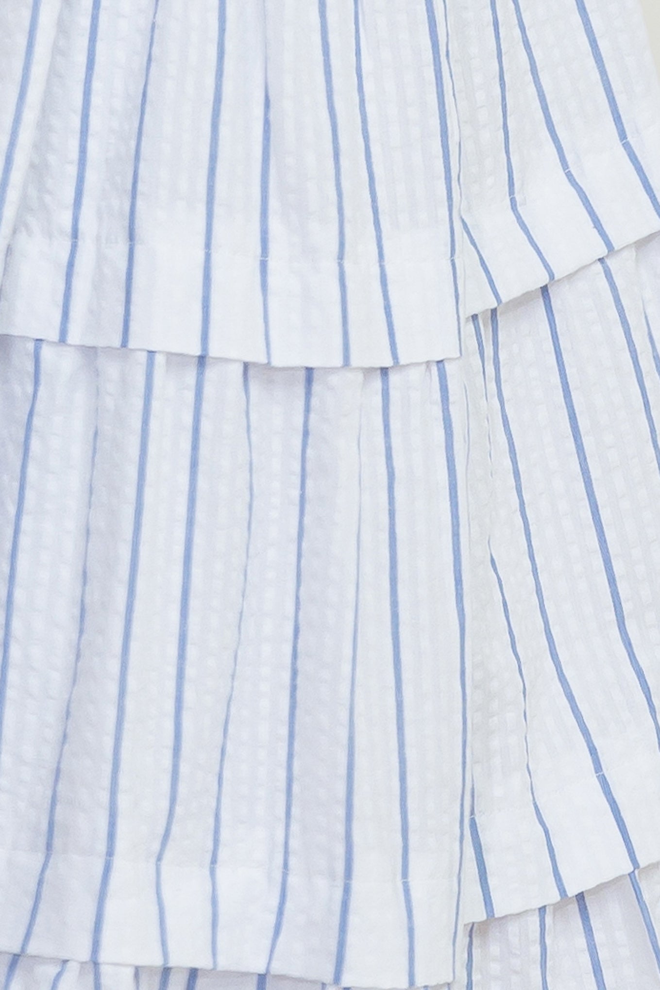 A striped woven midi dress featuring shirred top with front tie, smocked waist, tiered skirt and bare back with straps