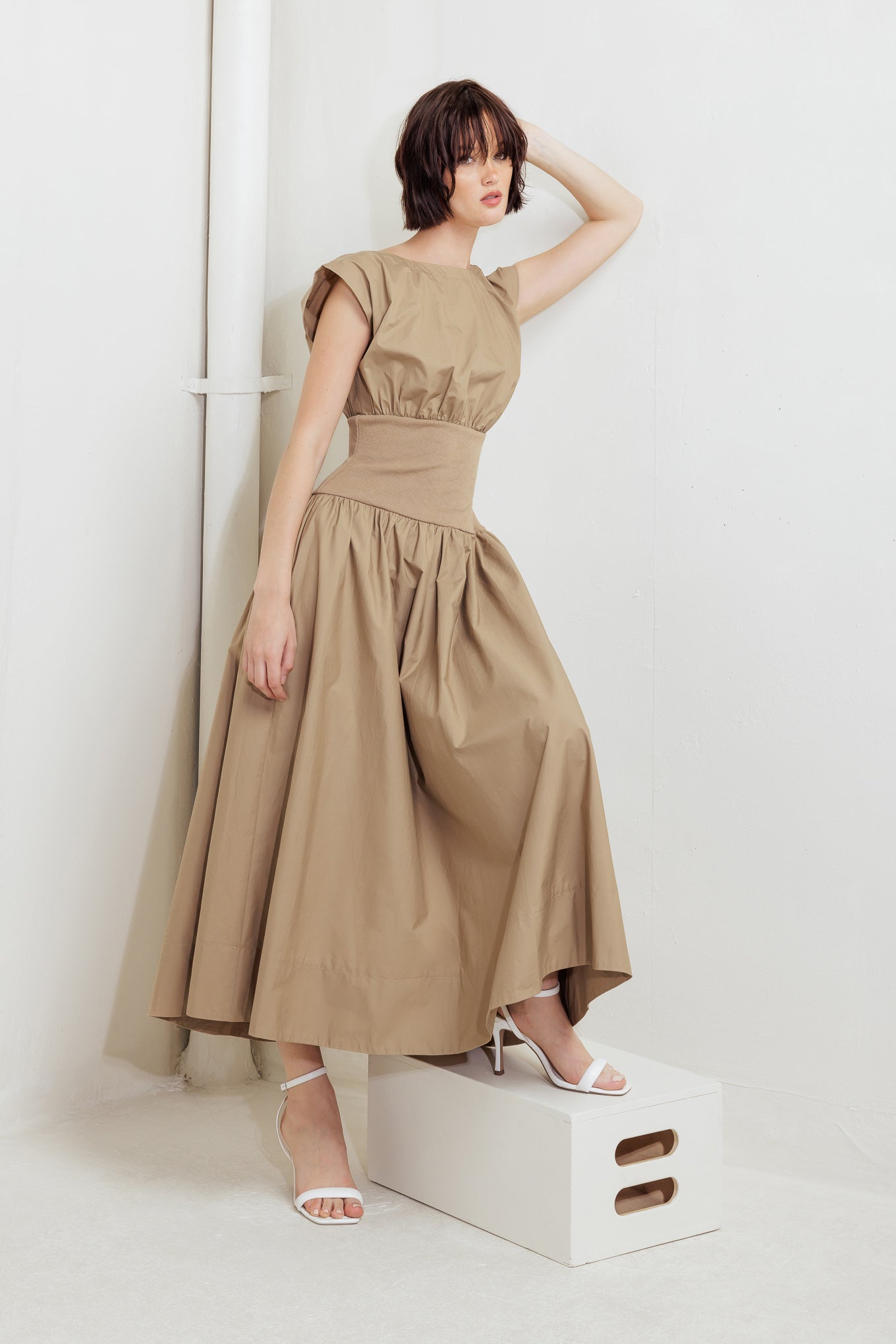 A solid woven midi dress featuring wide neckline, short sleeve, knit midriff, full skirt and back zipper closure