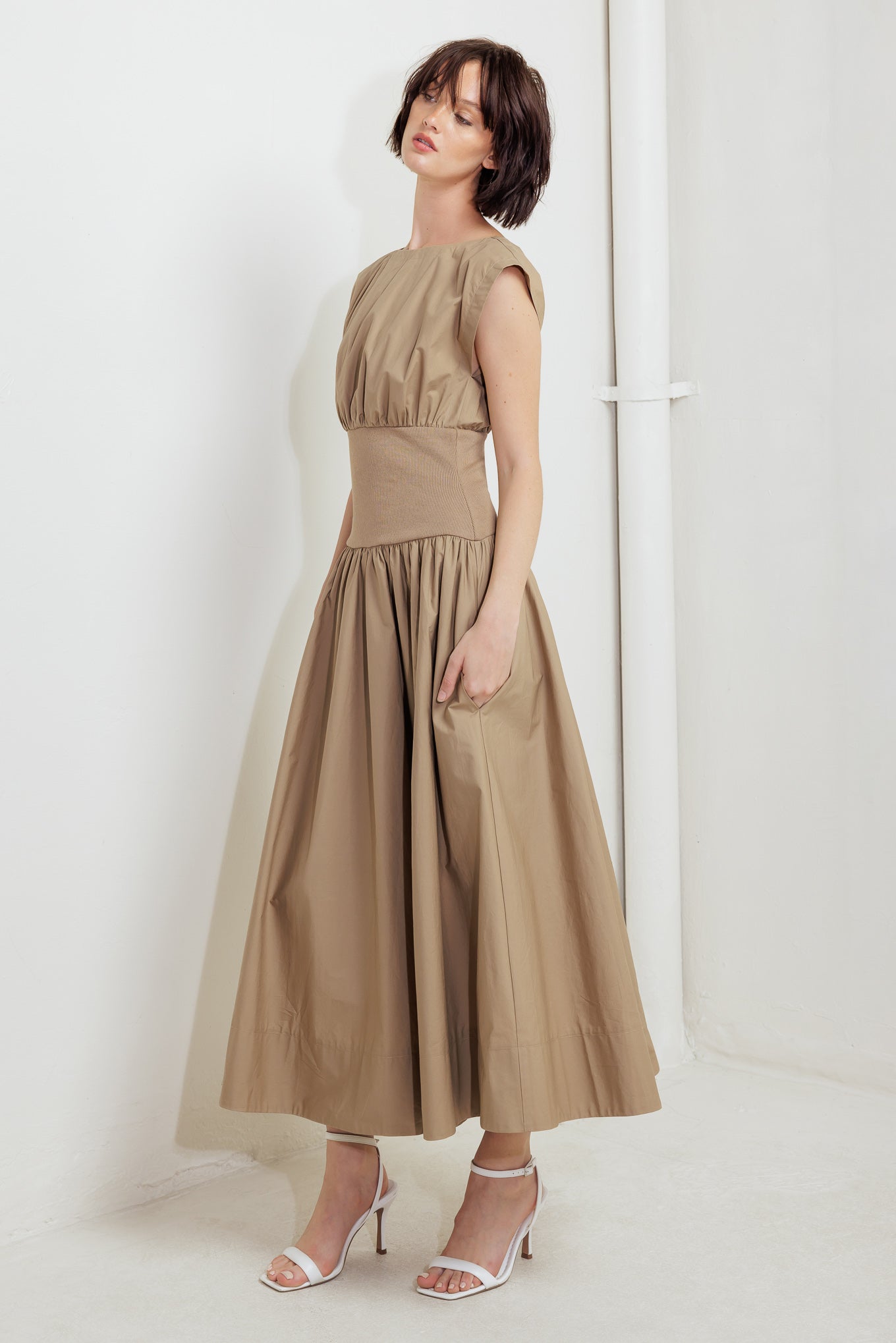 A solid woven midi dress featuring wide neckline, short sleeve, knit midriff, full skirt and back zipper closure