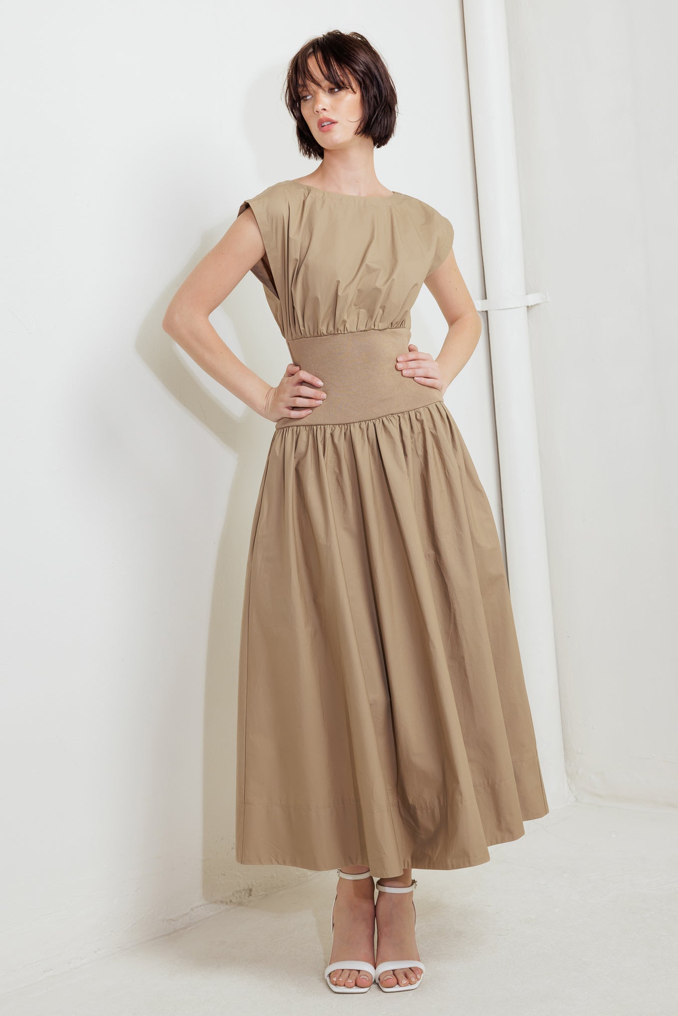 A solid woven midi dress featuring wide neckline, short sleeve, knit midriff, full skirt and back zipper closure
