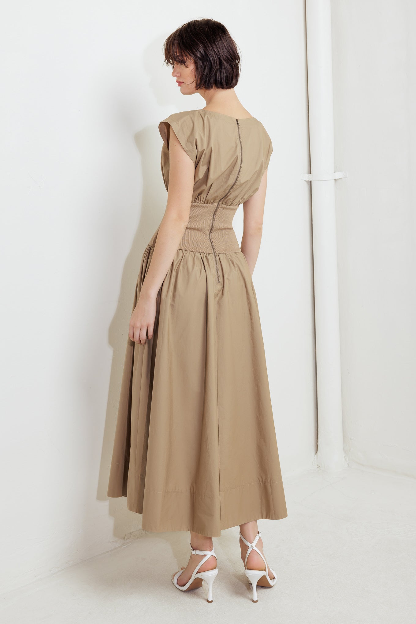 A solid woven midi dress featuring wide neckline, short sleeve, knit midriff, full skirt and back zipper closure
