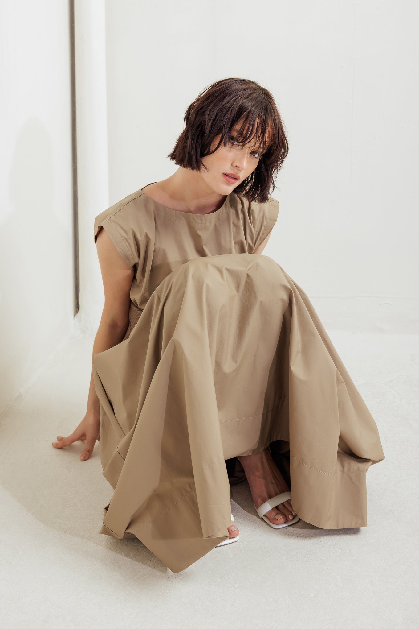 A solid woven midi dress featuring wide neckline, short sleeve, knit midriff, full skirt and back zipper closure