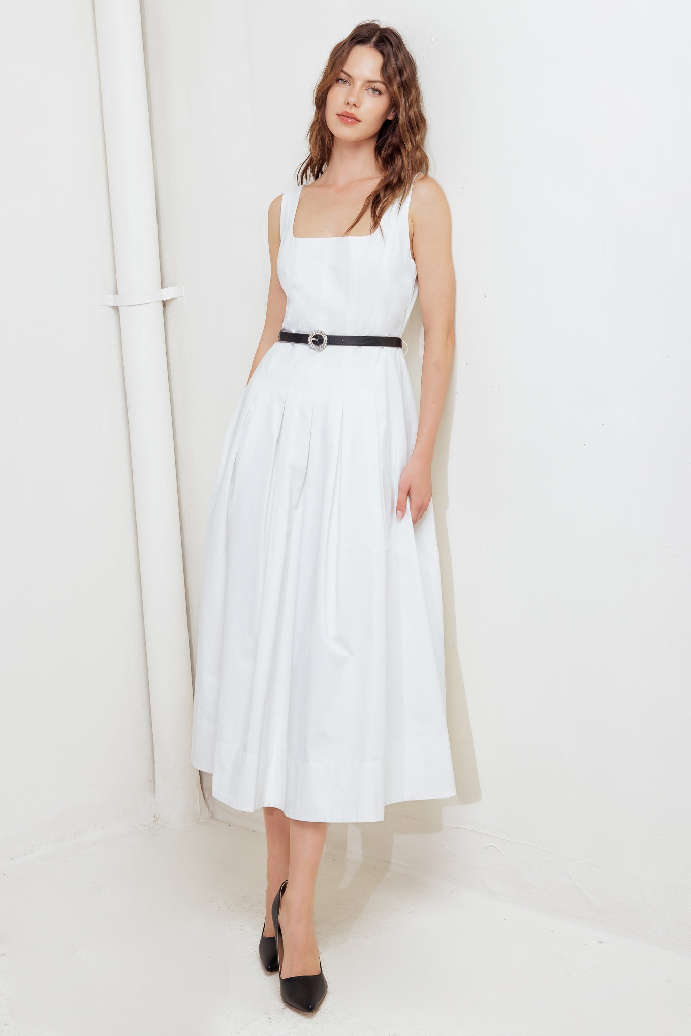 A solid woven midi dress featuring U neckline, sleeveless, contrasting belt, inverted pleat full skirt and back zipper closure