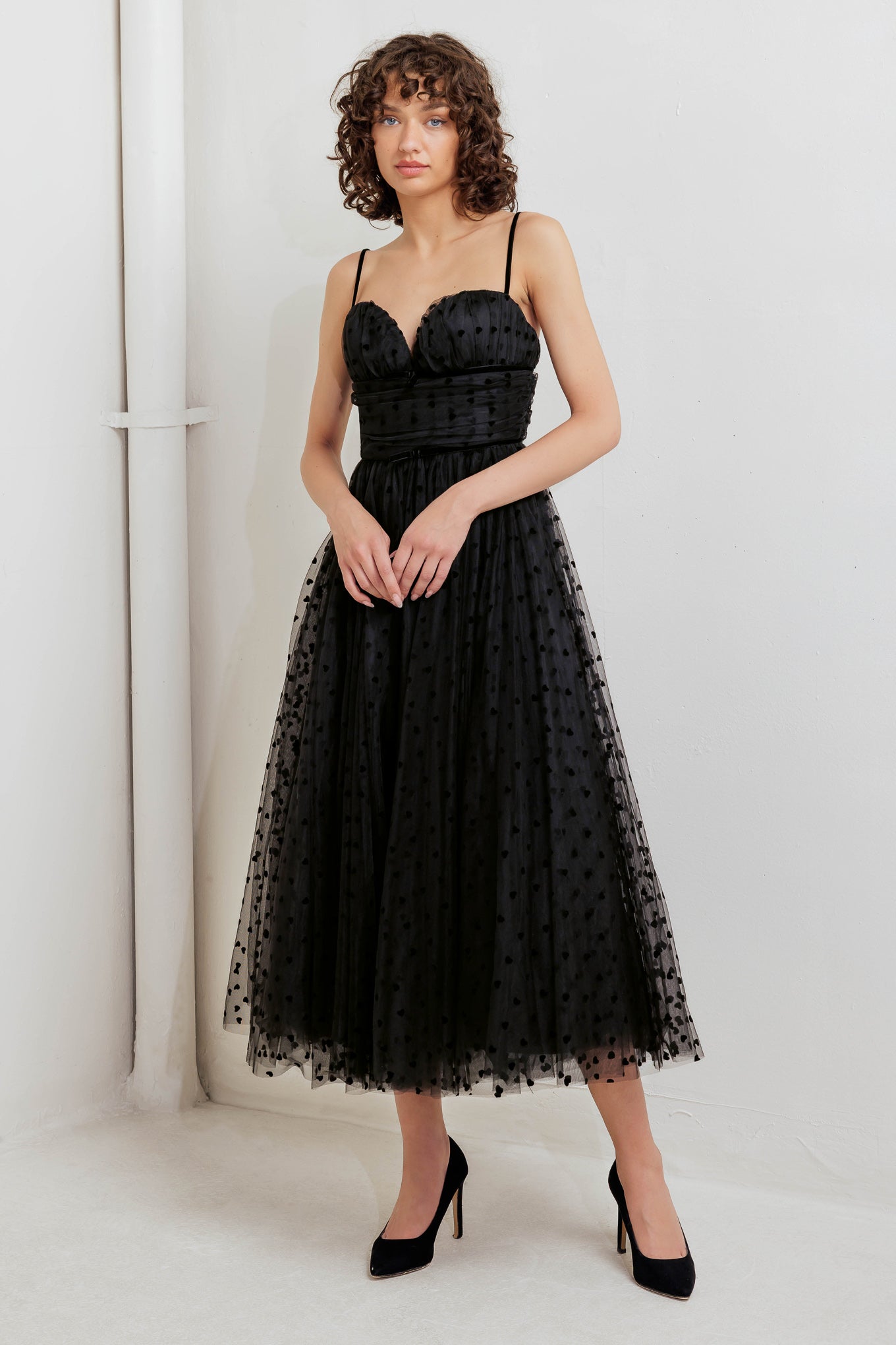 A dot tulle midi dress featuring sweetheart neckline, straps, full skirt and back zipper closure