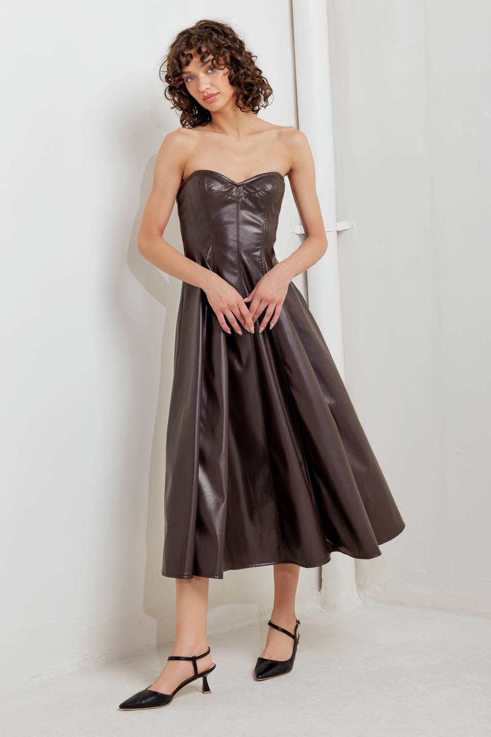 A faux leather midi dress featuring strapless sweetheart neckline, circle skirt and back zipper closure
