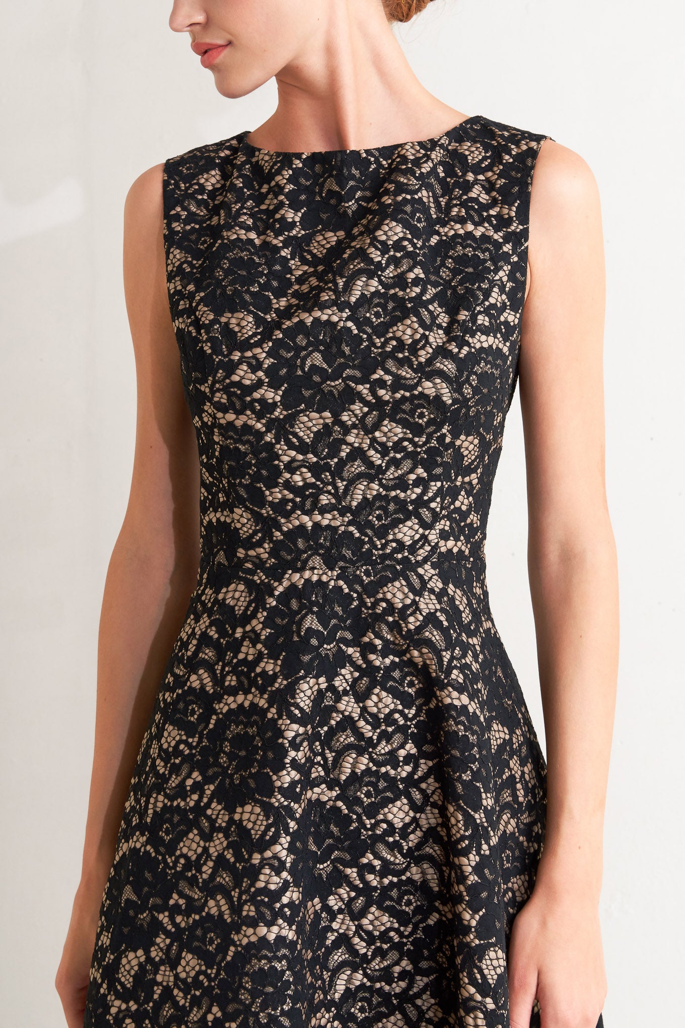 A woven lace midi dress featuring wide neckline, sleeveless, circle skirt and back zipper closure