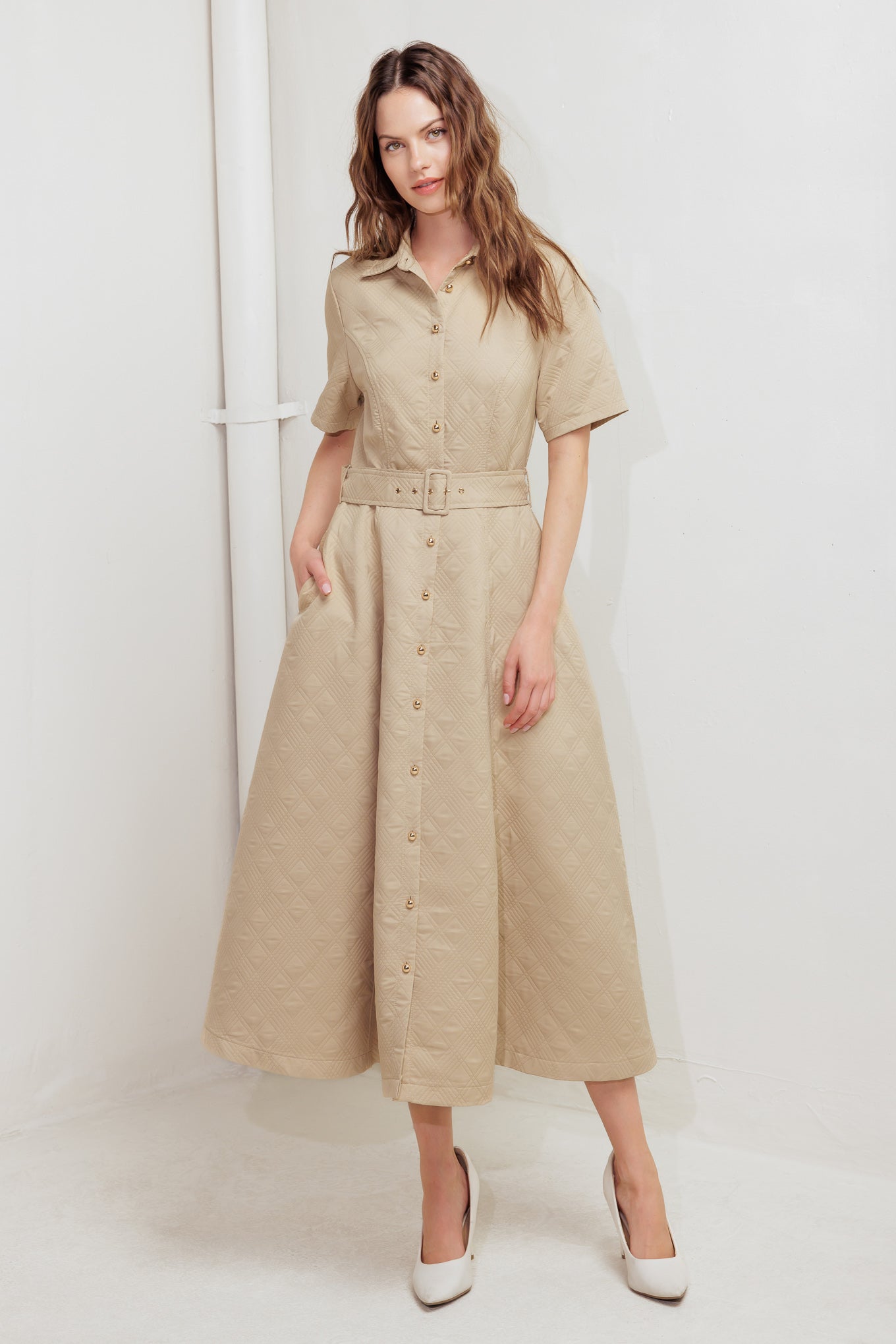 A textured woven midi dress featuring collar, short sleeve, button down, self belt and circle skirt
