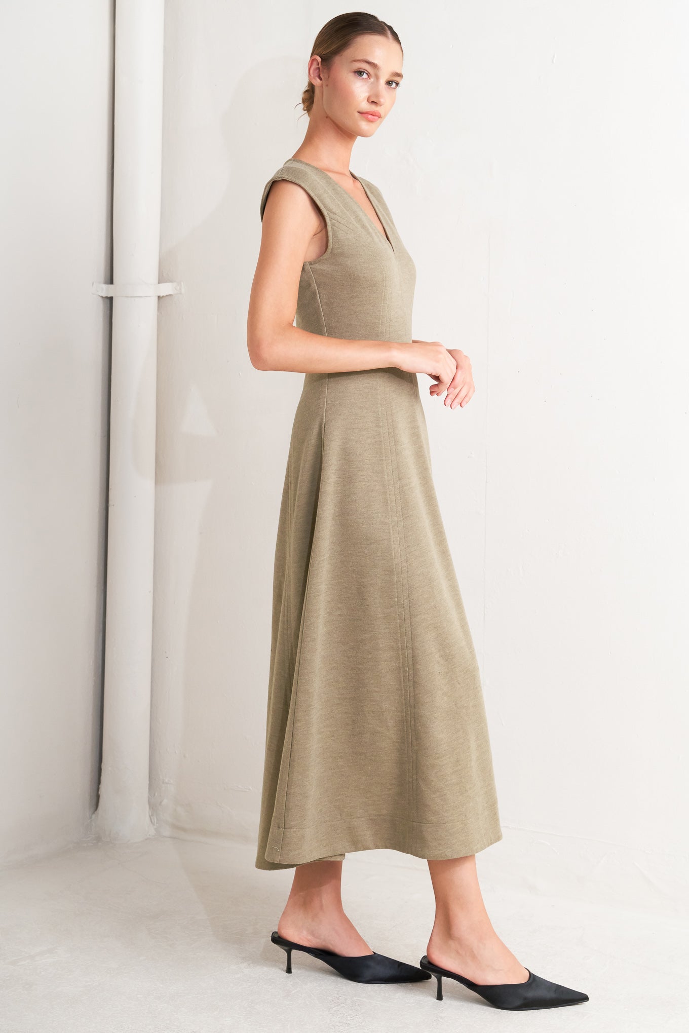 A woven knit midi dress featuring V neckline, sleeveless, circle skirt and back zipper closure