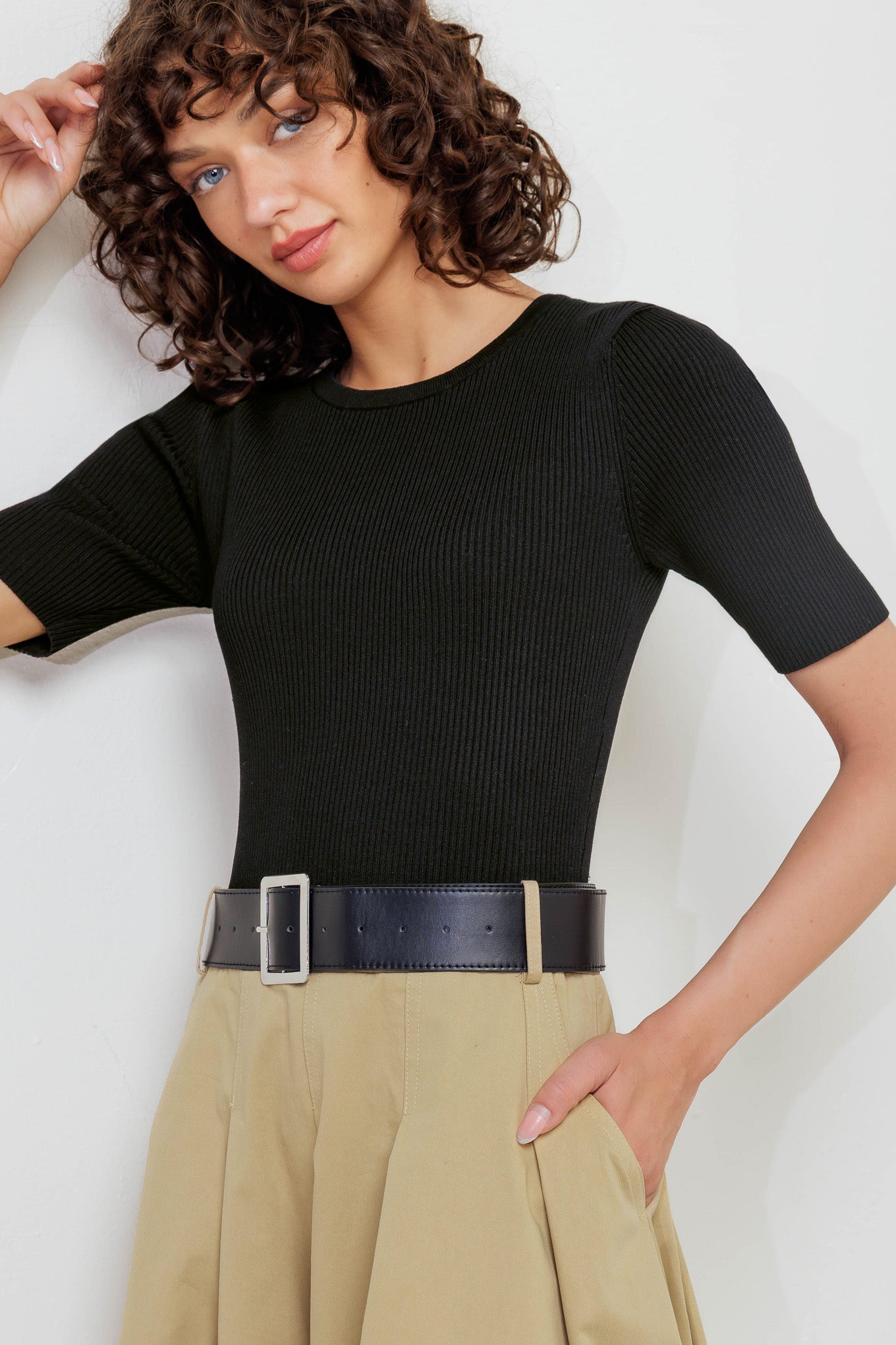 A sweater knit top and woven skirt dress featuring round neckline, short sleeve, contrasting belt, full midi skirt and back zipper closure