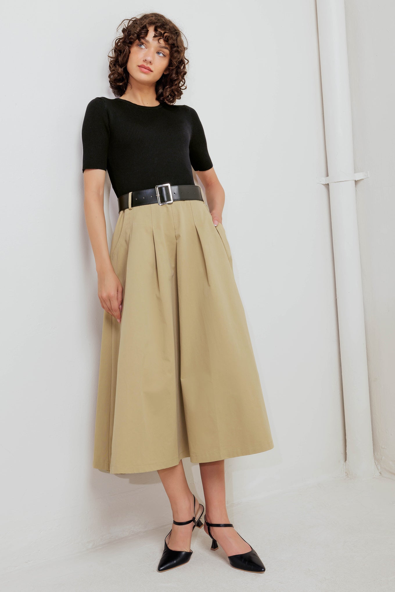 A sweater knit top and woven skirt dress featuring round neckline, short sleeve, contrasting belt, full midi skirt and back zipper closure