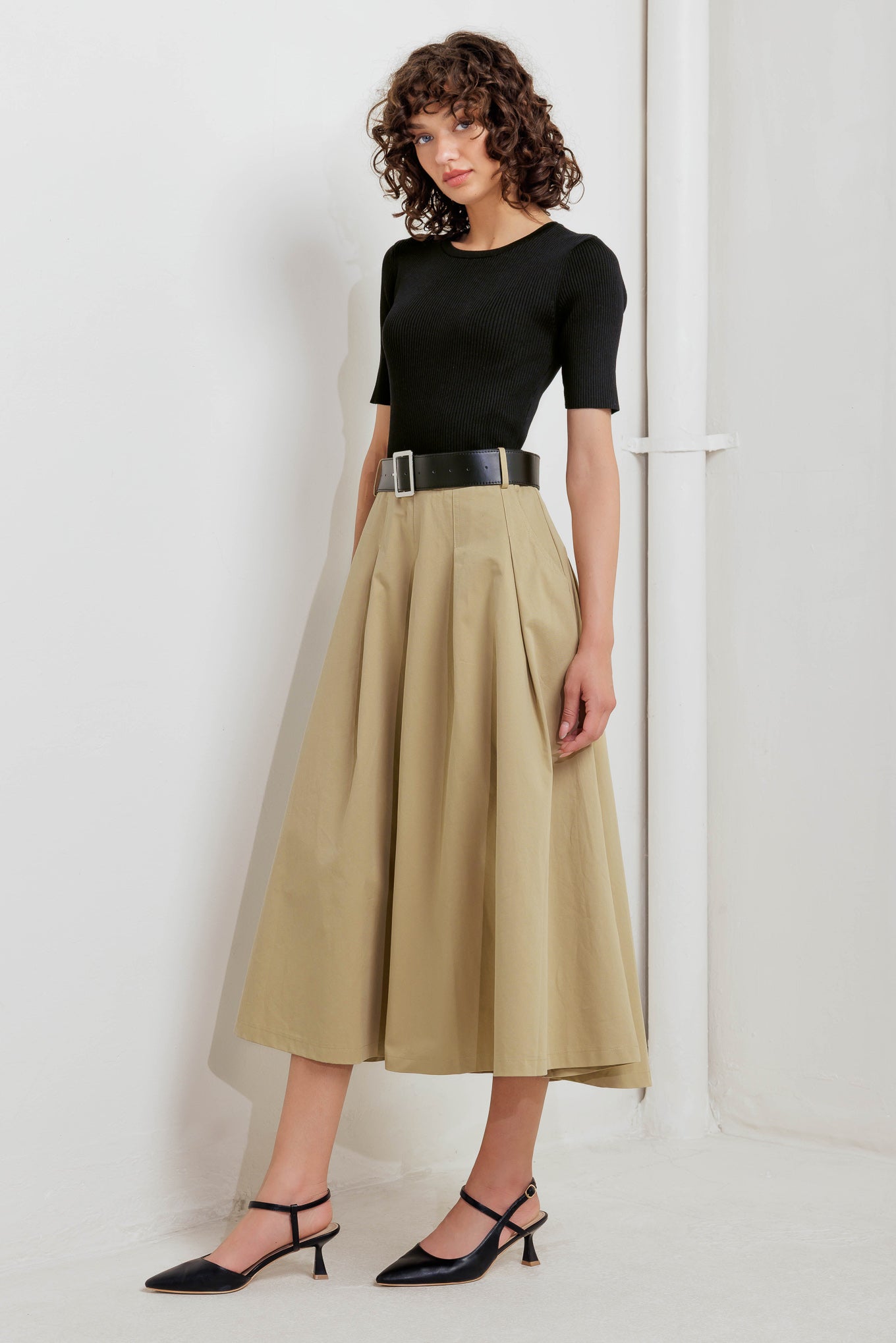 A sweater knit top and woven skirt dress featuring round neckline, short sleeve, contrasting belt, full midi skirt and back zipper closure