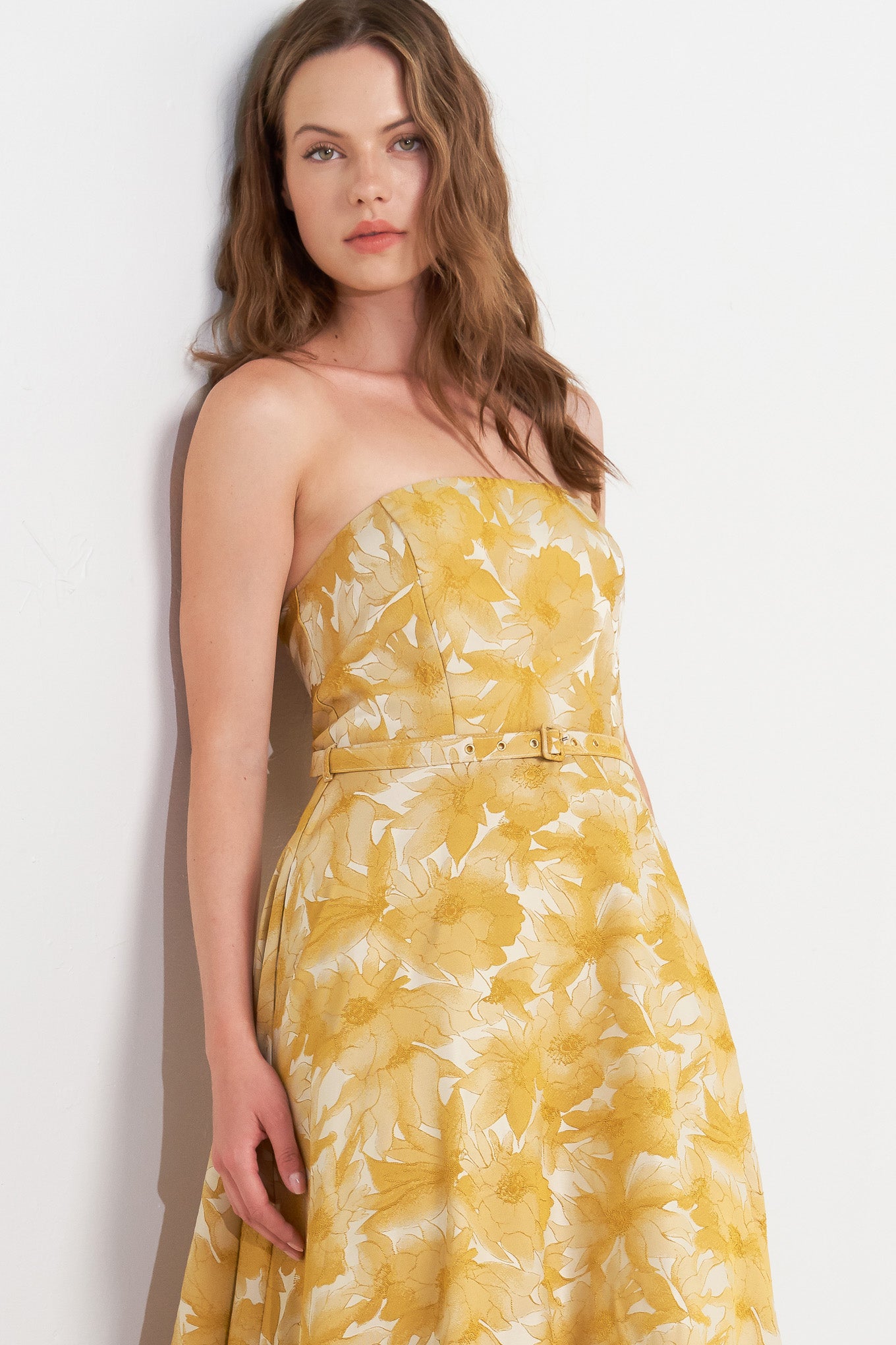 A woven jacquard midi dress featuring strapless, self belt, circle skirt and back zipper closure