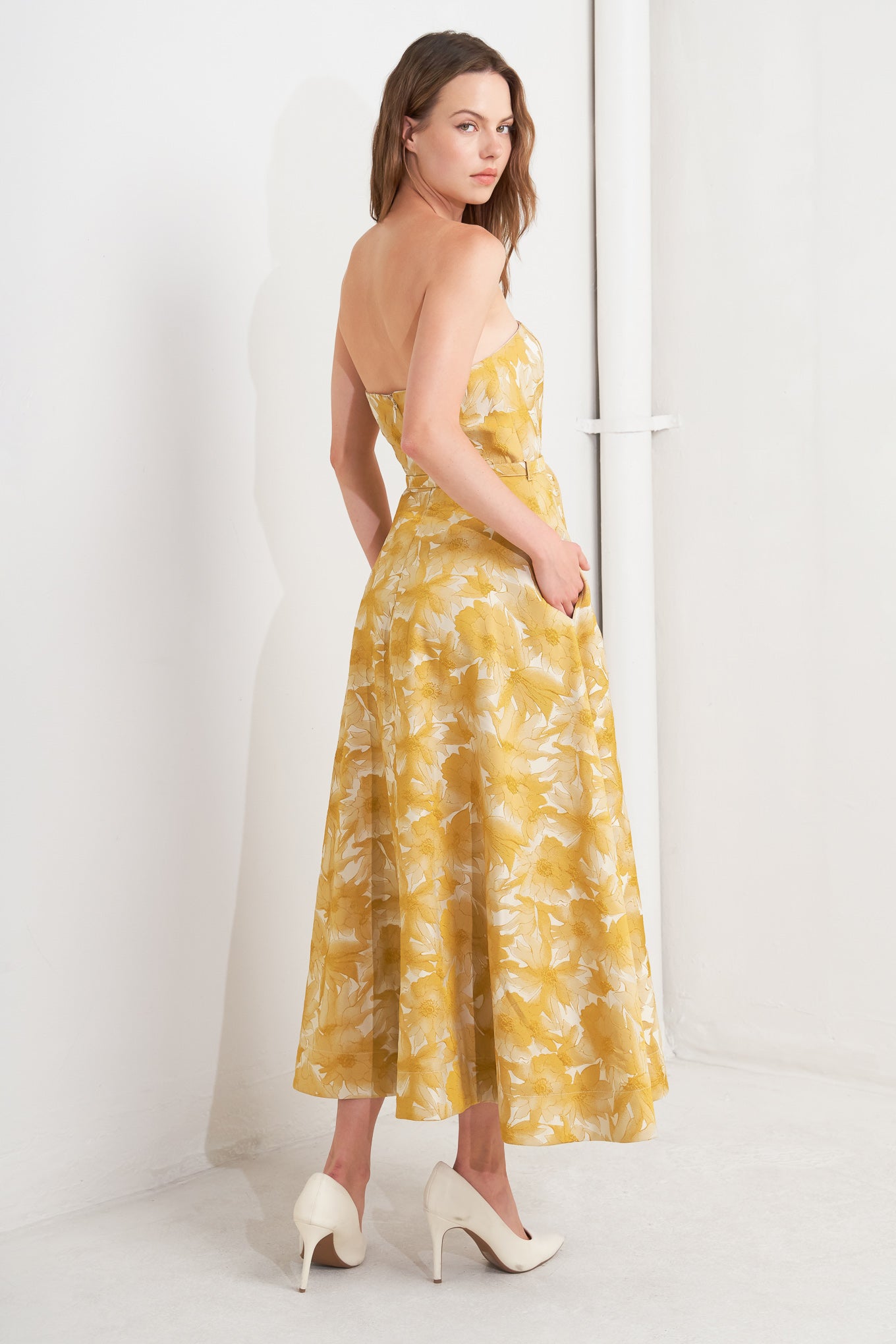 A woven jacquard midi dress featuring strapless, self belt, circle skirt and back zipper closure