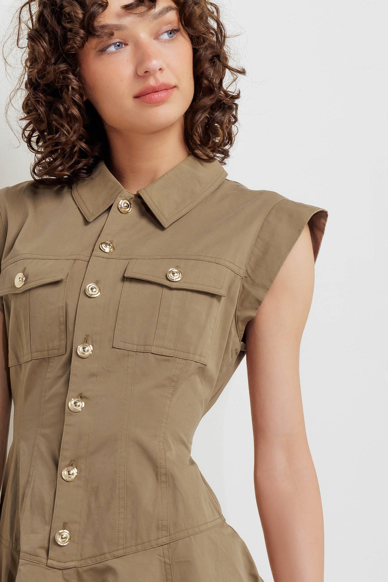 A solid woven mini dress featuring collar, short sleeve, front pocket, button down and circle skirt