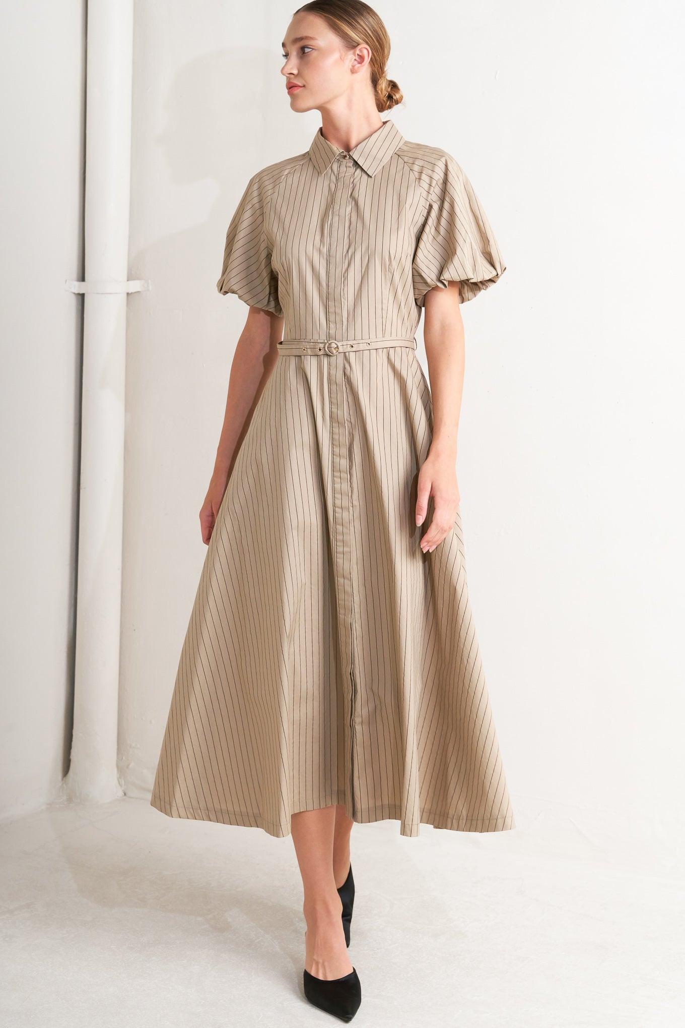 A striped woven midi dress featuring collar, raglan short puff sleeve, hidden button down, self belt and circle skirt