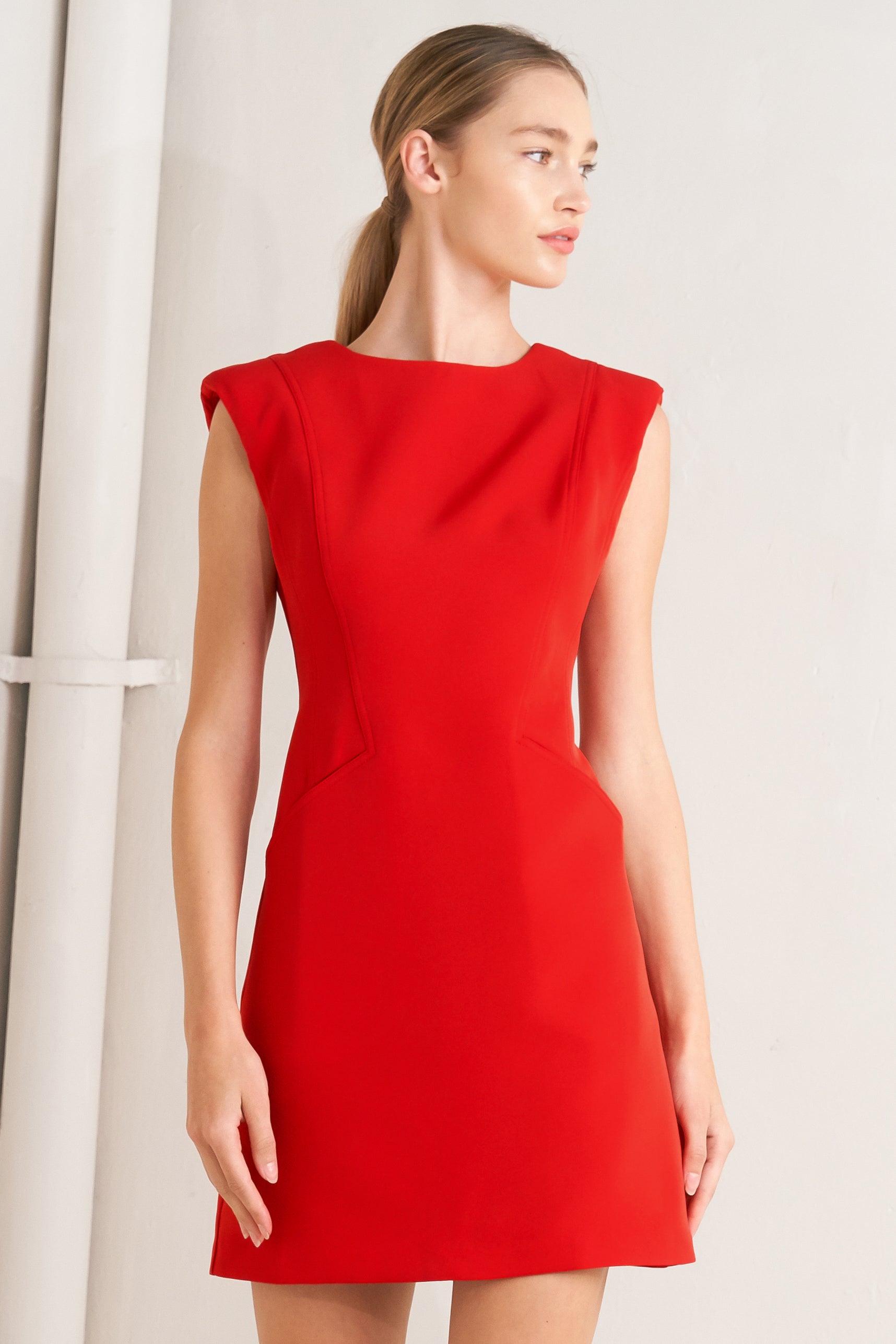 Woman wearing a red shift mini dress featuring wide round neckline, cap sleeve, pockets and back zipper closure | FREEMARKET