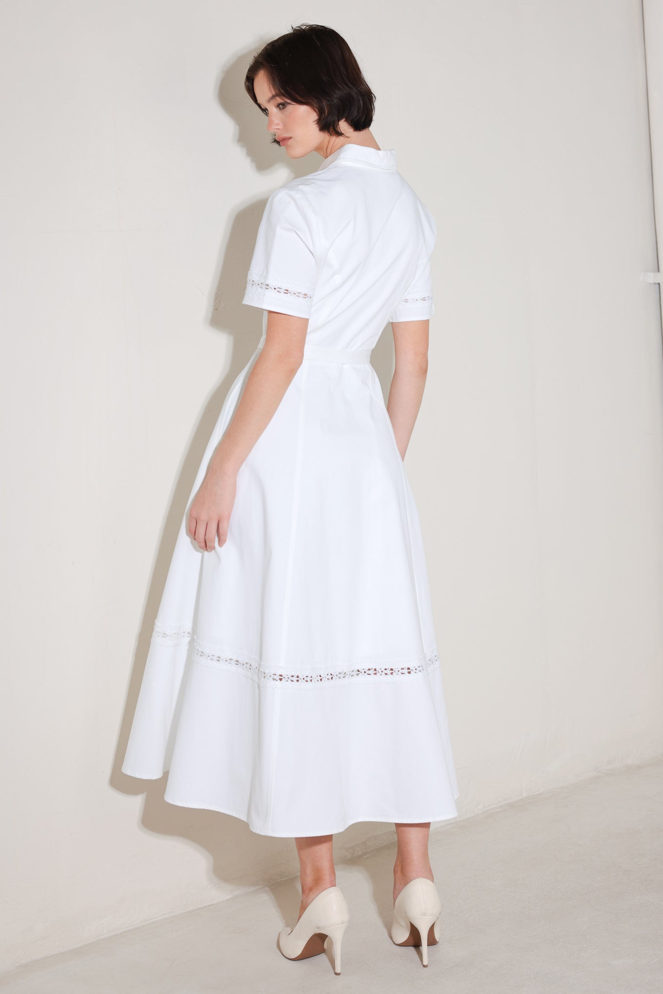 A solid woven midi dress featuring collar, short sleeve with lace inset, front button down, self belt, circle skirt with lace inset bottom
Details:
Self : 100% Cotton
Lining : 100% Polyester
Size & Fit
- Model is 5`8" And Wearing Size Small
- Measurements Taken From Size Small
- Approx. Length: 50"