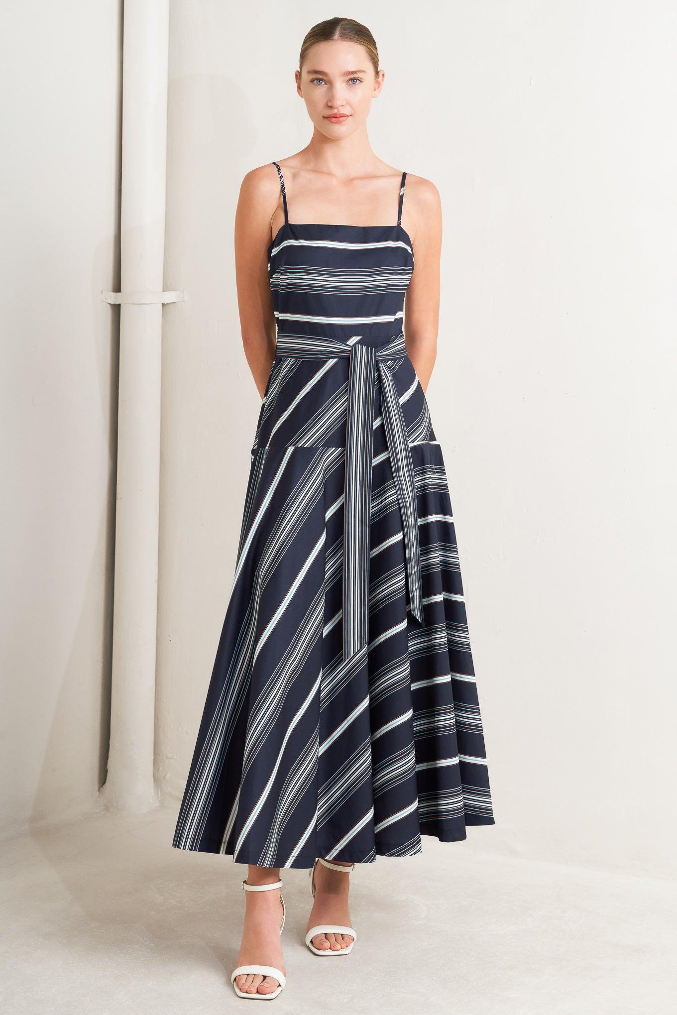 A striped woven midi dress featuring straight neckline, straps, self sash tie, circle skirt and back zipper closure
Details:
Self : 100% Cotton
Size & Fit
- Model is 5`8" And Wearing Size Small
- Measurements Taken From Size Small
- Approx. Length: 53" Flying Tomato
