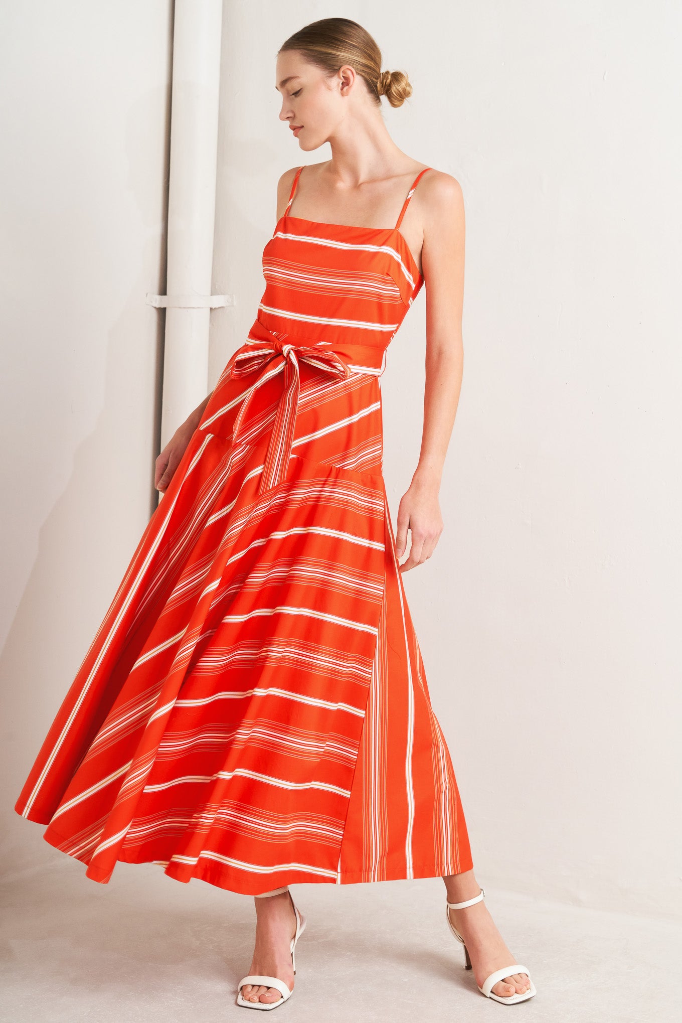 A striped woven midi dress featuring straight neckline, straps, self sash tie, circle skirt and back zipper closure
Details:
Self : 100% Cotton
Size & Fit
- Model is 5`8" And Wearing Size Small
- Measurements Taken From Size Small
- Approx. Length: 53" Flying Tomato