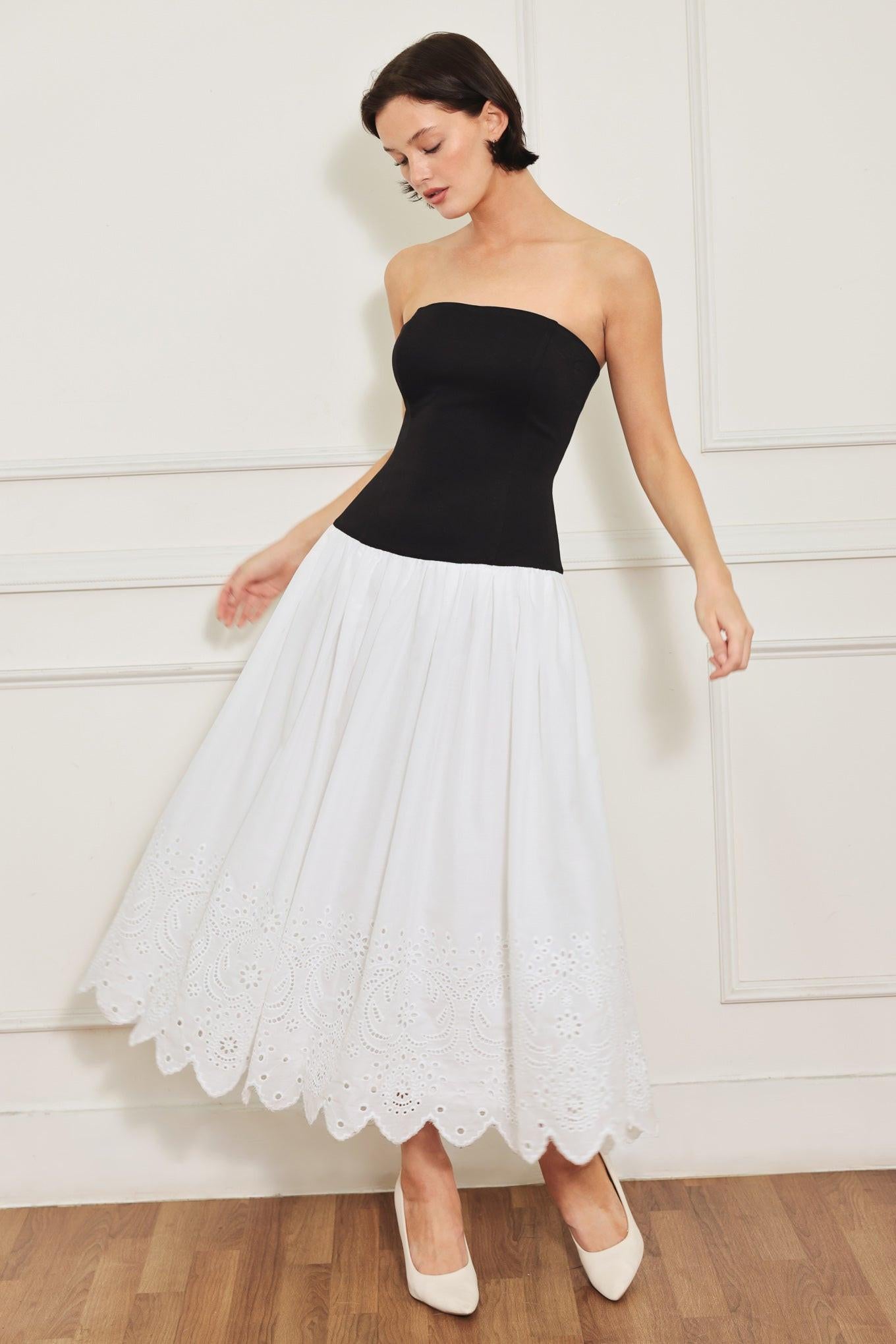 A knit/woven combination midi dress featuring strapless knit top, woven eyelet full skirt and back zipper closure
Details:
Self : 100% Cotton
Contrast : 49% Rayon 44% Polyester 7% Spandex
Lining : 100% Polyester
Size & Fit
- Model is 5`8" And Wearing Size Small
- Measurements Taken From Size Small
- Approx. Length: 43"