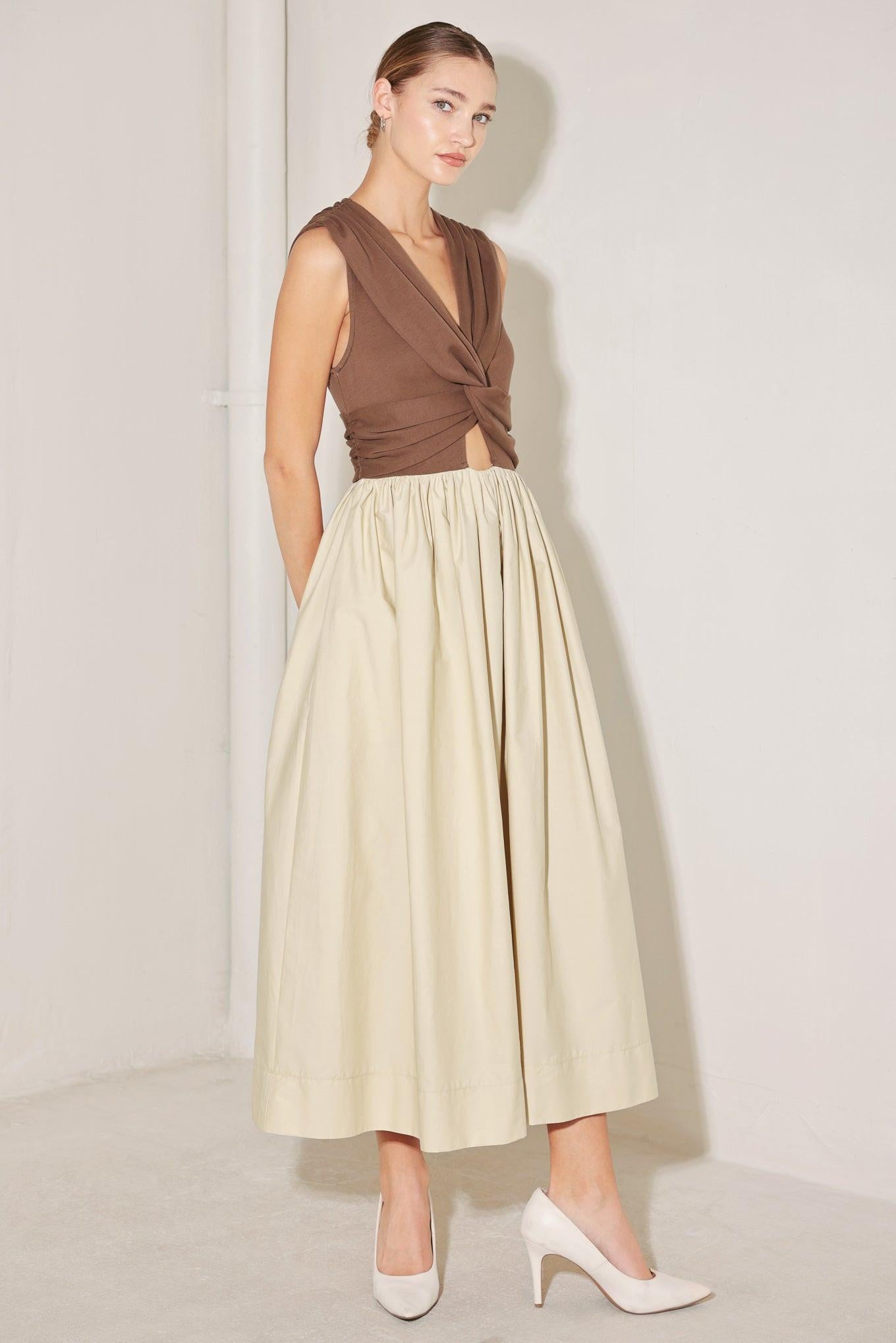 A solid midi dress featuring knit top with V neckline, sleeveless, twist front detail with cut out, full woven skirt and back zipper closure
Details:
Self : 100% Cotton
Contrast : 96% Cotton 4% Spandex
Lining : 100% Polyester
Size & Fit
- Model is 5`8" And Wearing Size Small
- Measurements Taken From Size Small
- Approx. Length: 52"