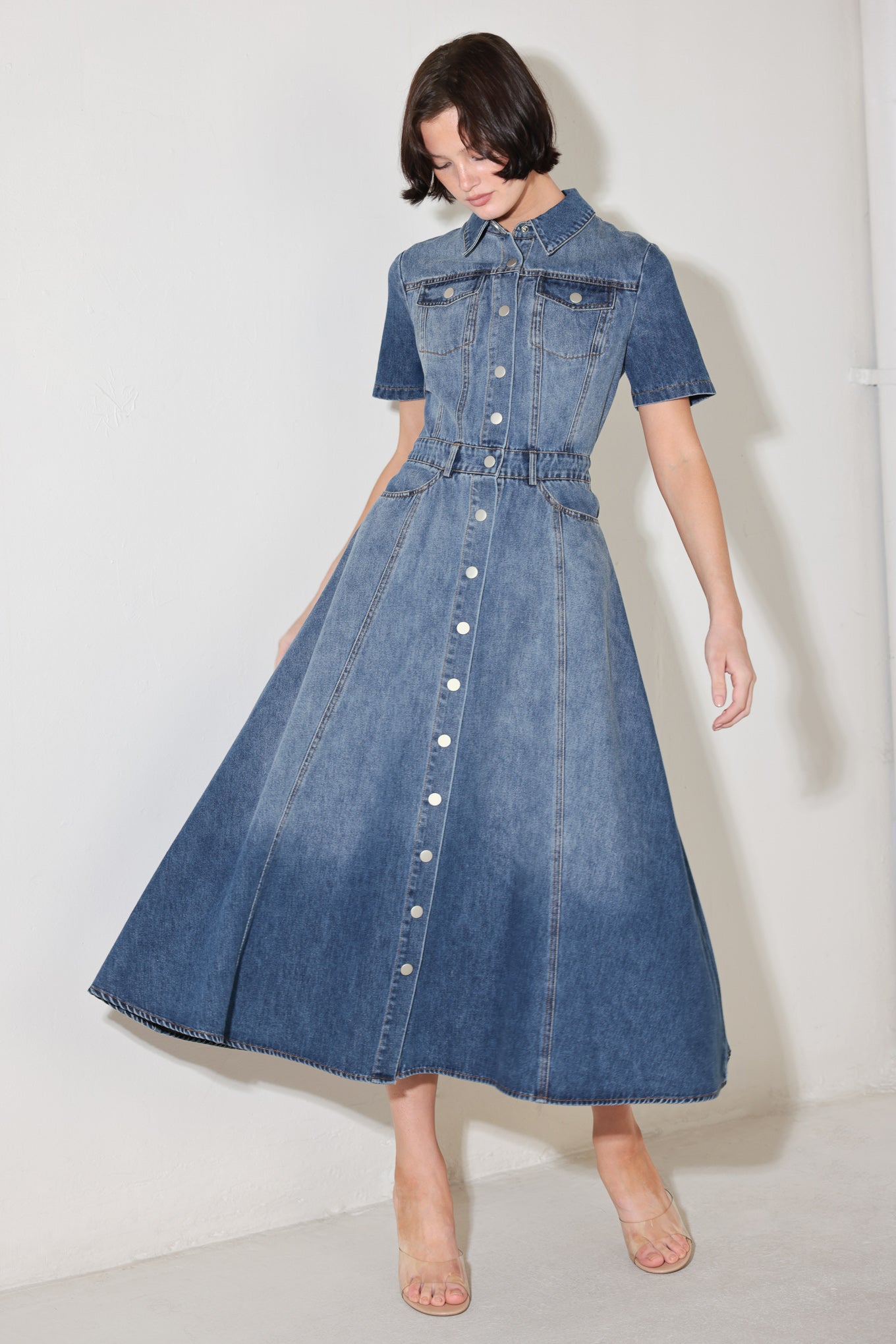 A washed denim midi dress featuring, collar, short sleeve, pockets, front button down and circle skirt
Details:
Self : 90% Cotton 10% Polyester
Size & Fit
- Model is 5`8" And Wearing Size Small
- Measurements Taken From Size Small
- Approx. Length: 50"