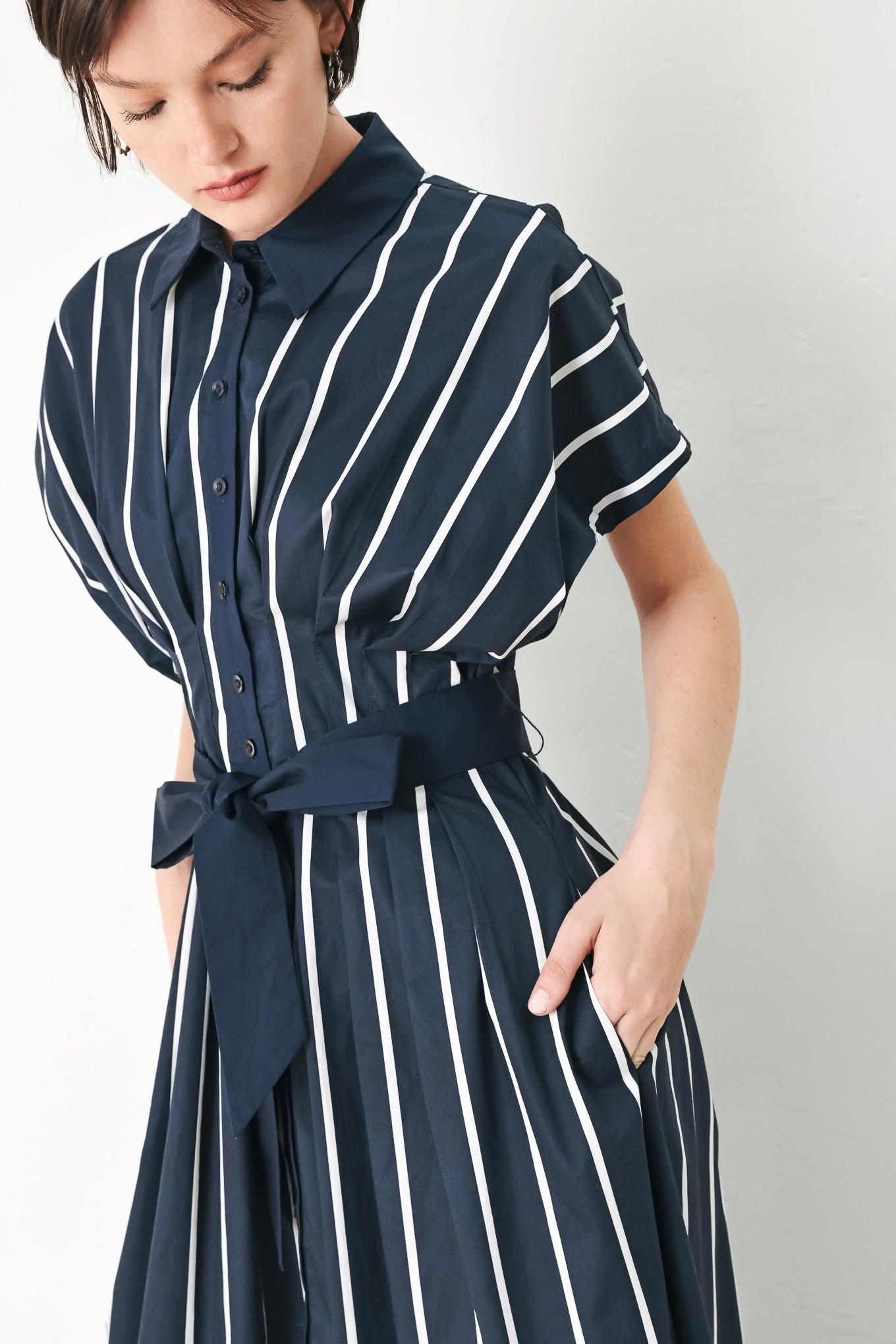 A striped woven midi dress featuring collar, button down, corset waist, solid self sash tie and full skirt
