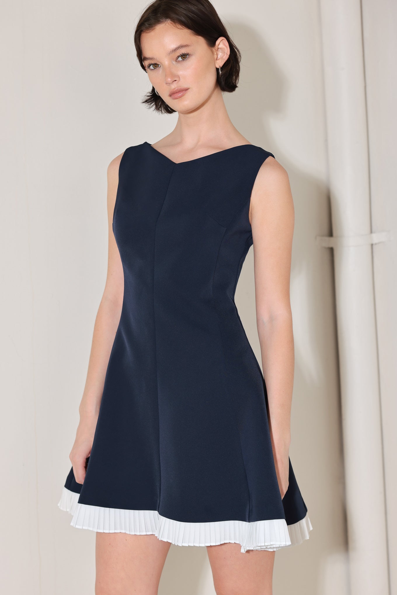 A solid woven mini dress featuring V neckline, sleeveless, circle skirt with contrasting pleated hem and back zipper closure
Details:
Self : 95% Polyester 5% Spandex
Contrast : 100% Polyester
Size & Fit
- Model is 5`8" And Wearing Size Small
- Measurements Taken From Size Small
- Approx. Length: 34"