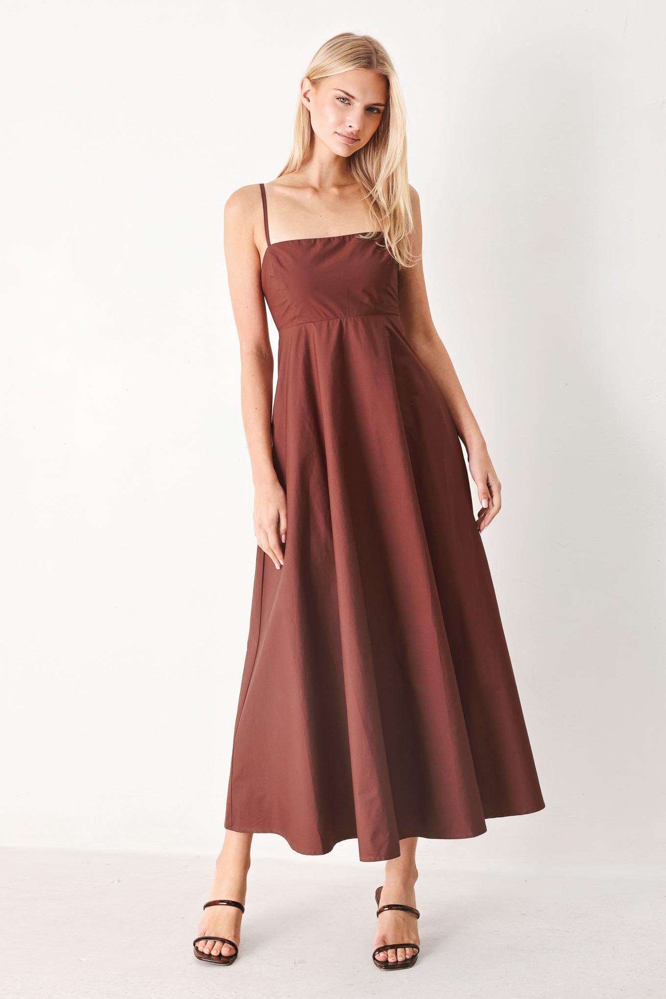 Woman wearing a dark rose midi dress featuring straight neckline, straps, circle skirt and back zipper closure | FREEMARKET