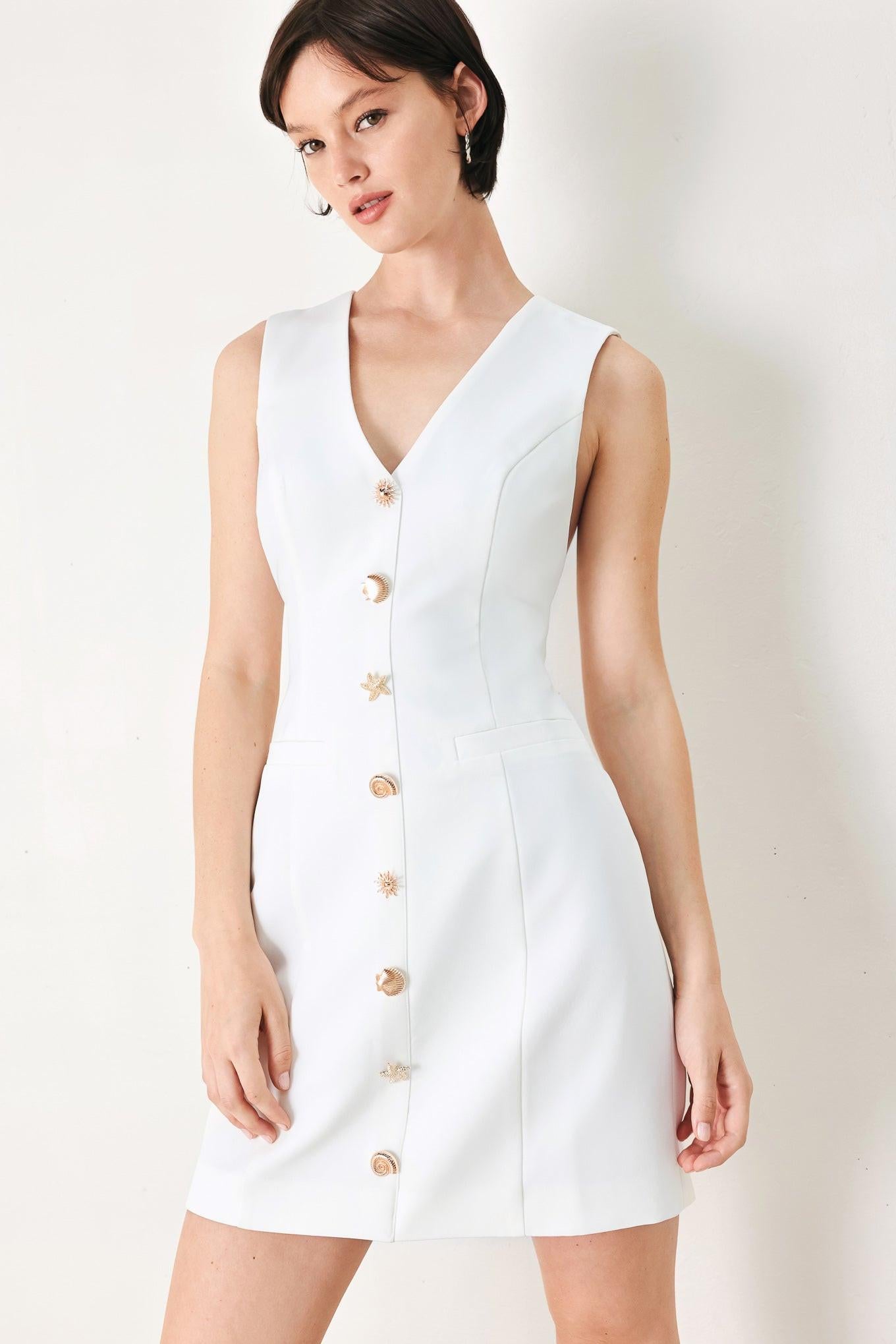 A solid woven mini dress featuring V neckline, sleeveless, button detail and back zipper closure