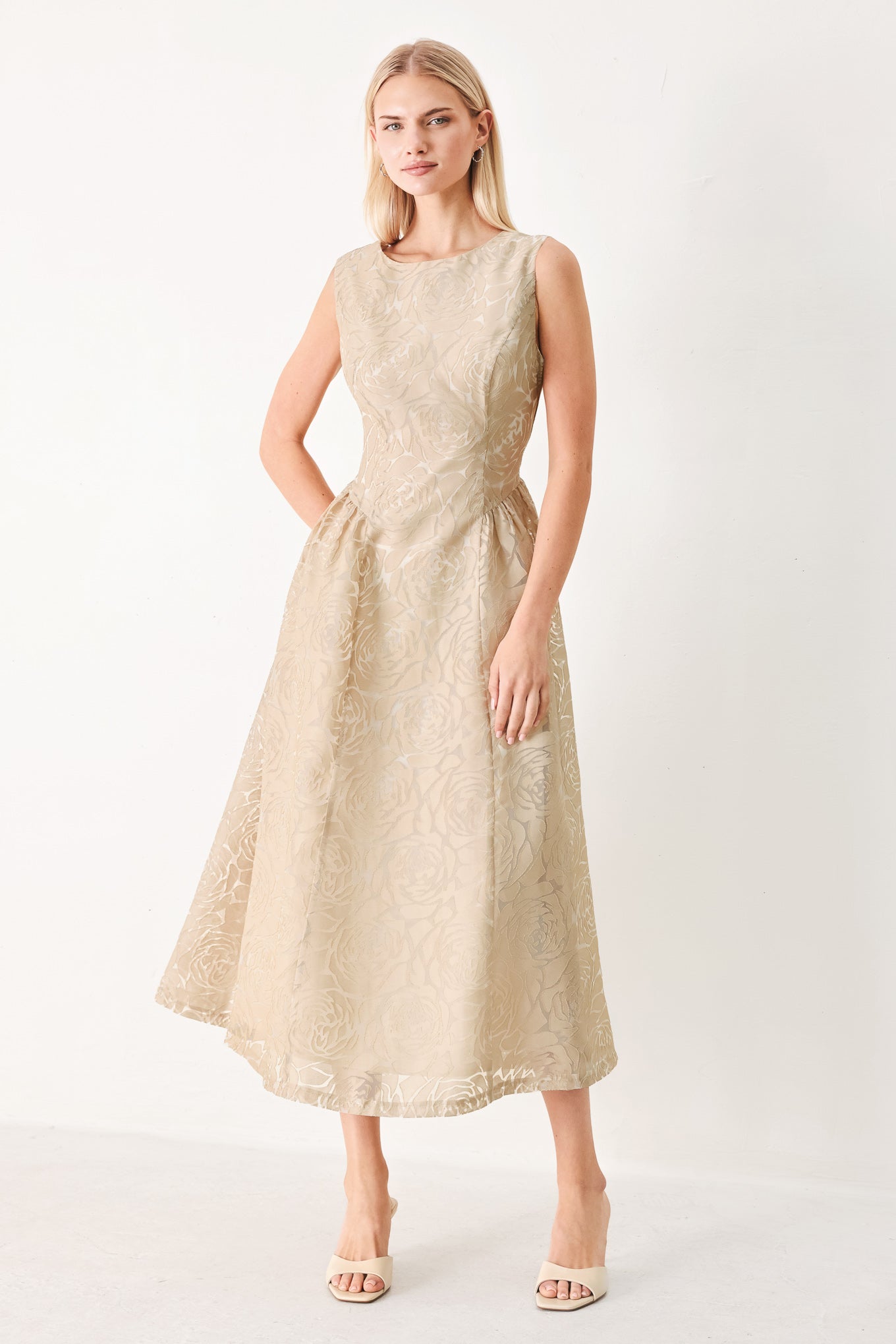 Woman wearing a beige lace burnout organza midi dress featuring round neckline, sleeveless, side shirring detail and back zipper closure | FREEMARKET