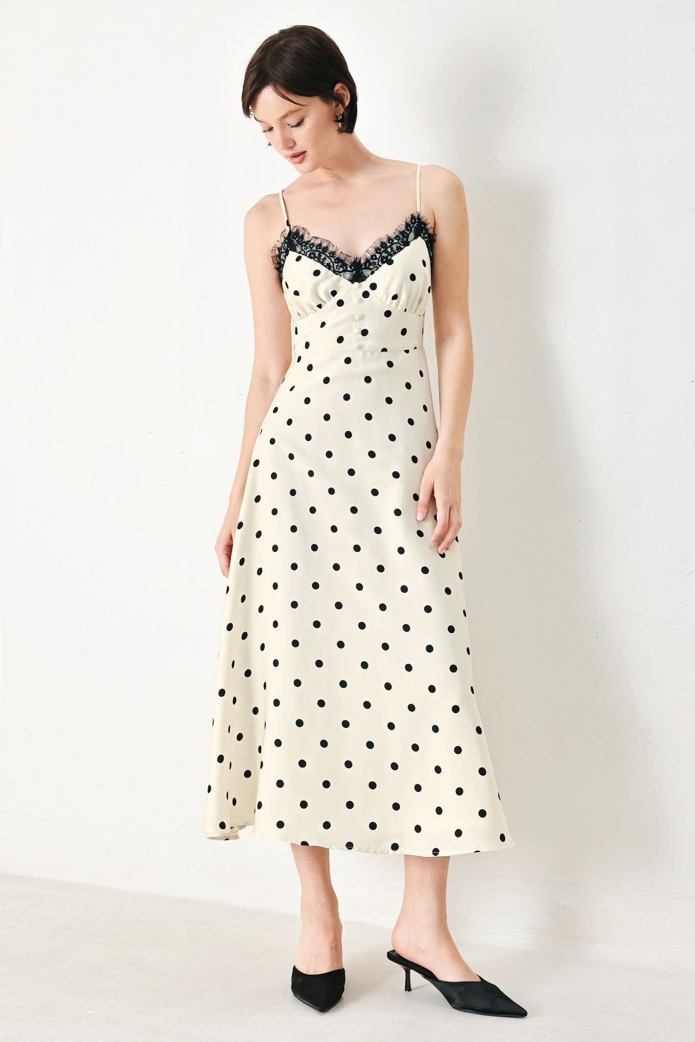 A printed woven midi dress featuring cami top with lace trim, straps, waist yoke with buttons, circle skirt and back zipper closure