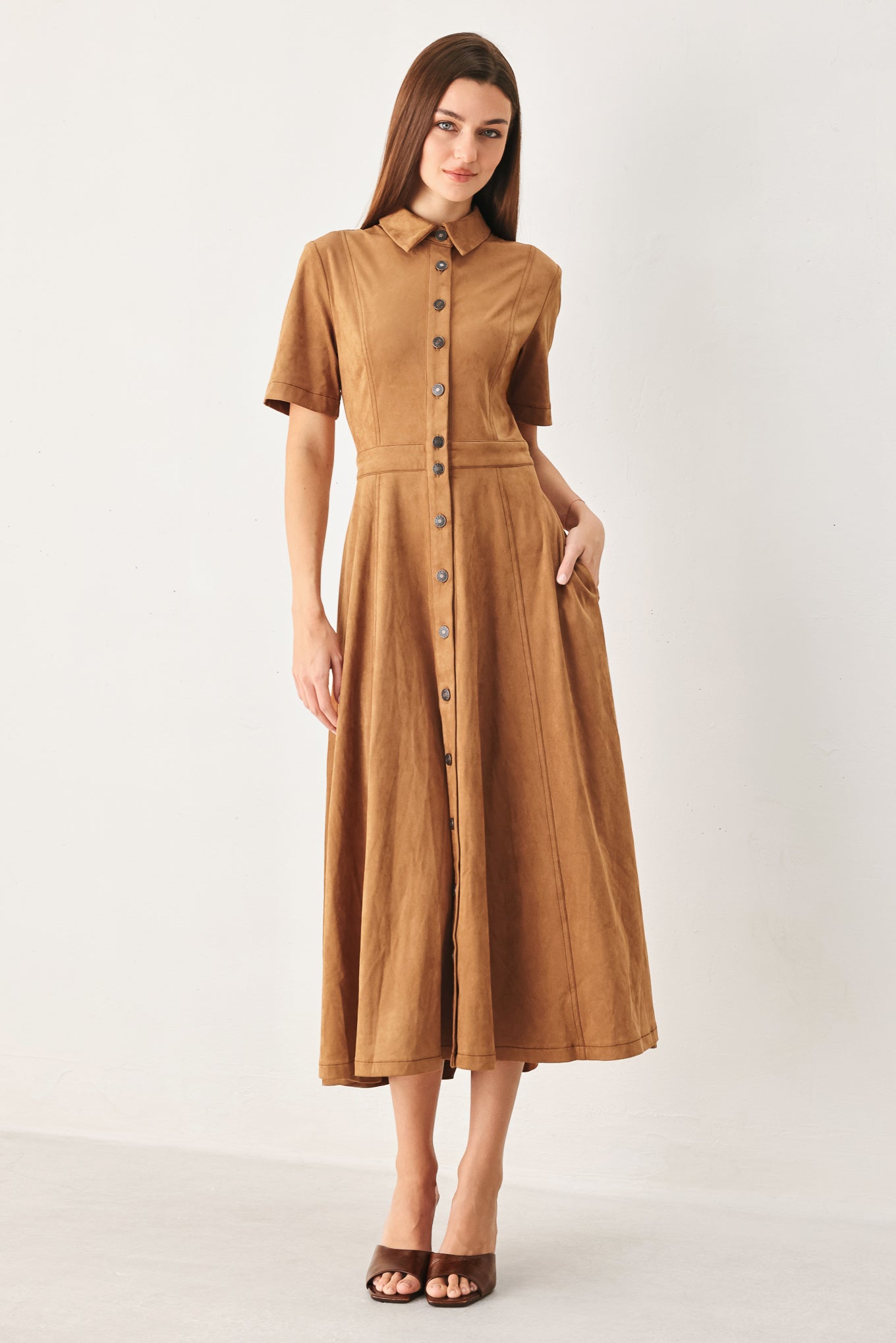 Woman wearing a camel brown faux suede midi shirt dress with short sleeve, front button down and circle skirt | FREEMARKET