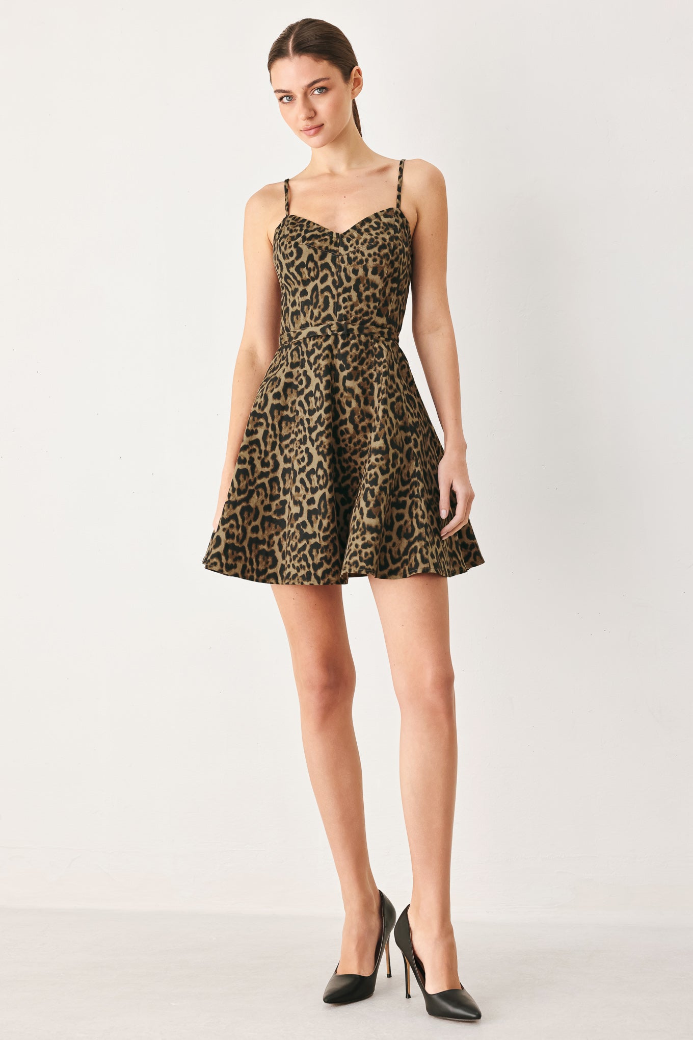 Woman wearing a leopard printed woven mini dress featuring bustier top, straps, self belt, circle skirt and back zipper closure | FREEMARKET