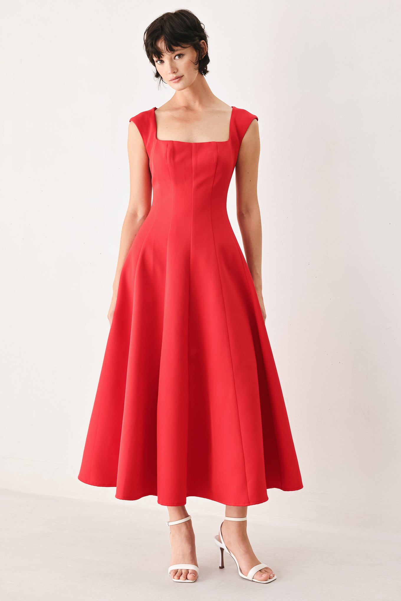 Woman wearing a red midi dress featuring square neckline, cap sleeve, circle skirt and back zipper closure | FREEMARKET