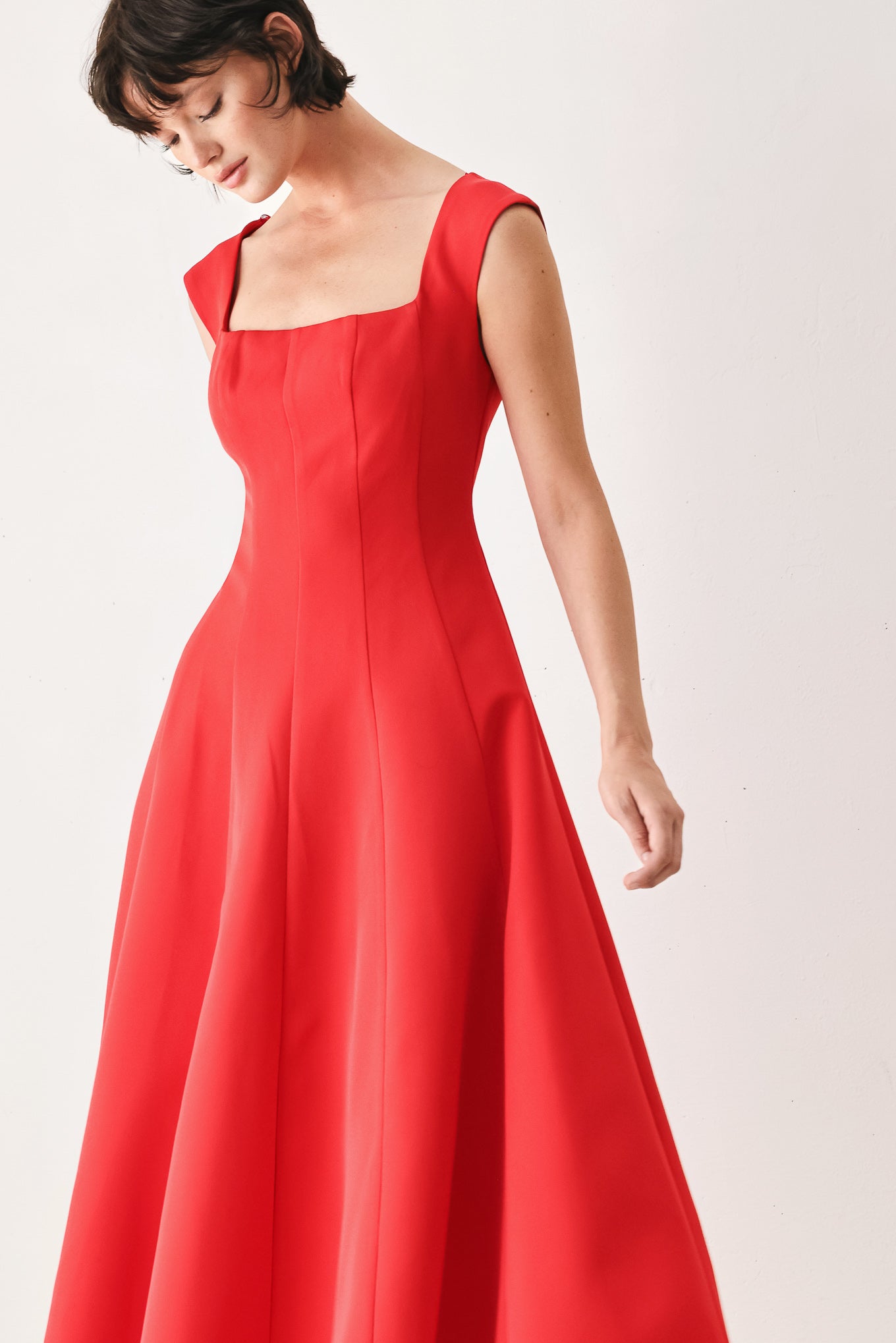 Woman wearing a red midi dress featuring square neckline, cap sleeve, circle skirt and back zipper closure | FREEMARKET